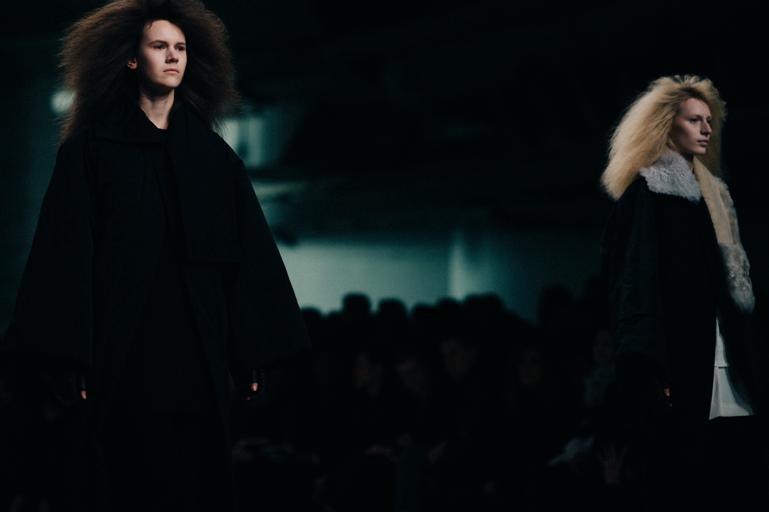 Two models wearing black on runway