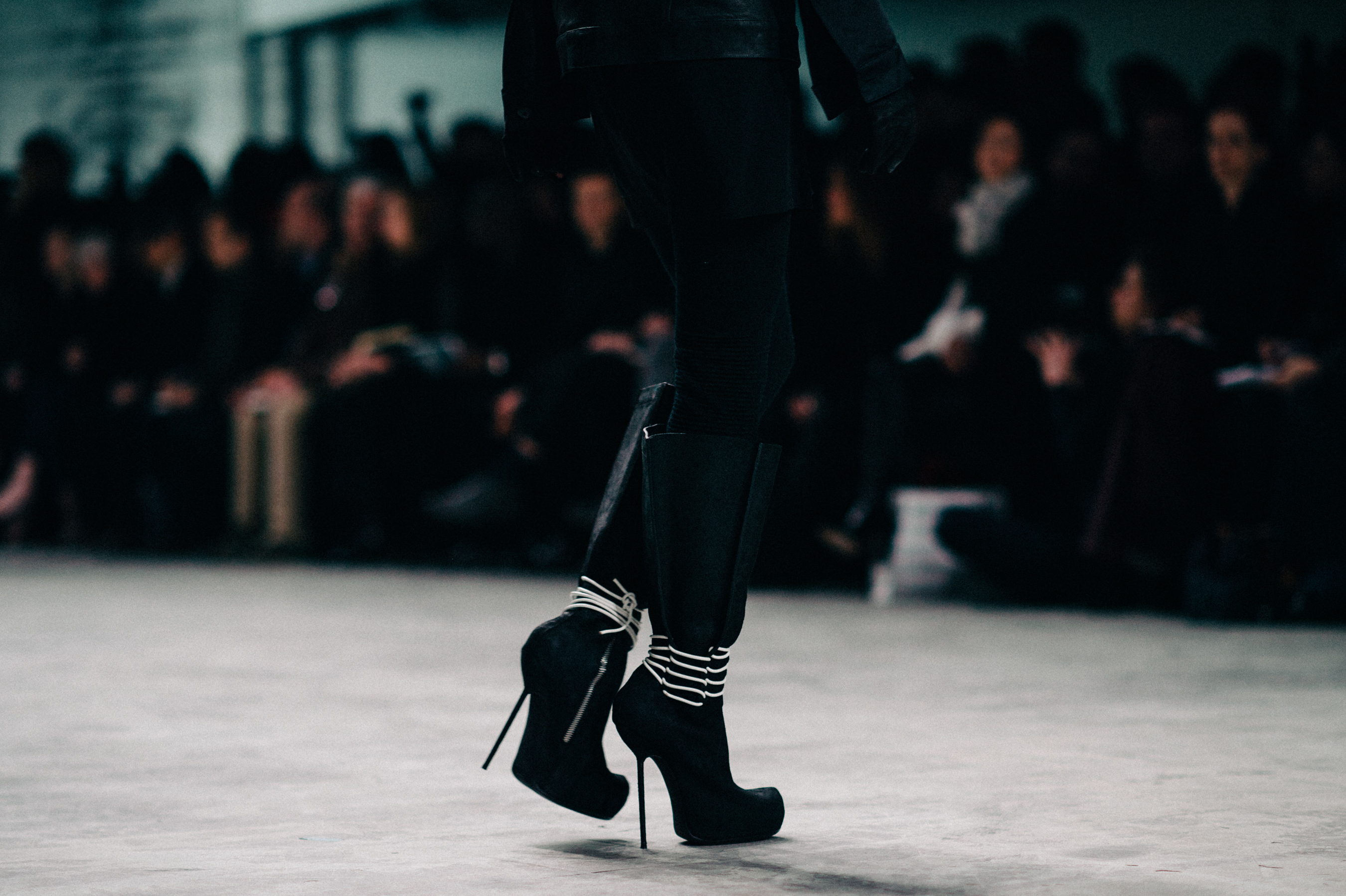 Model wearing stiletto boots on runway