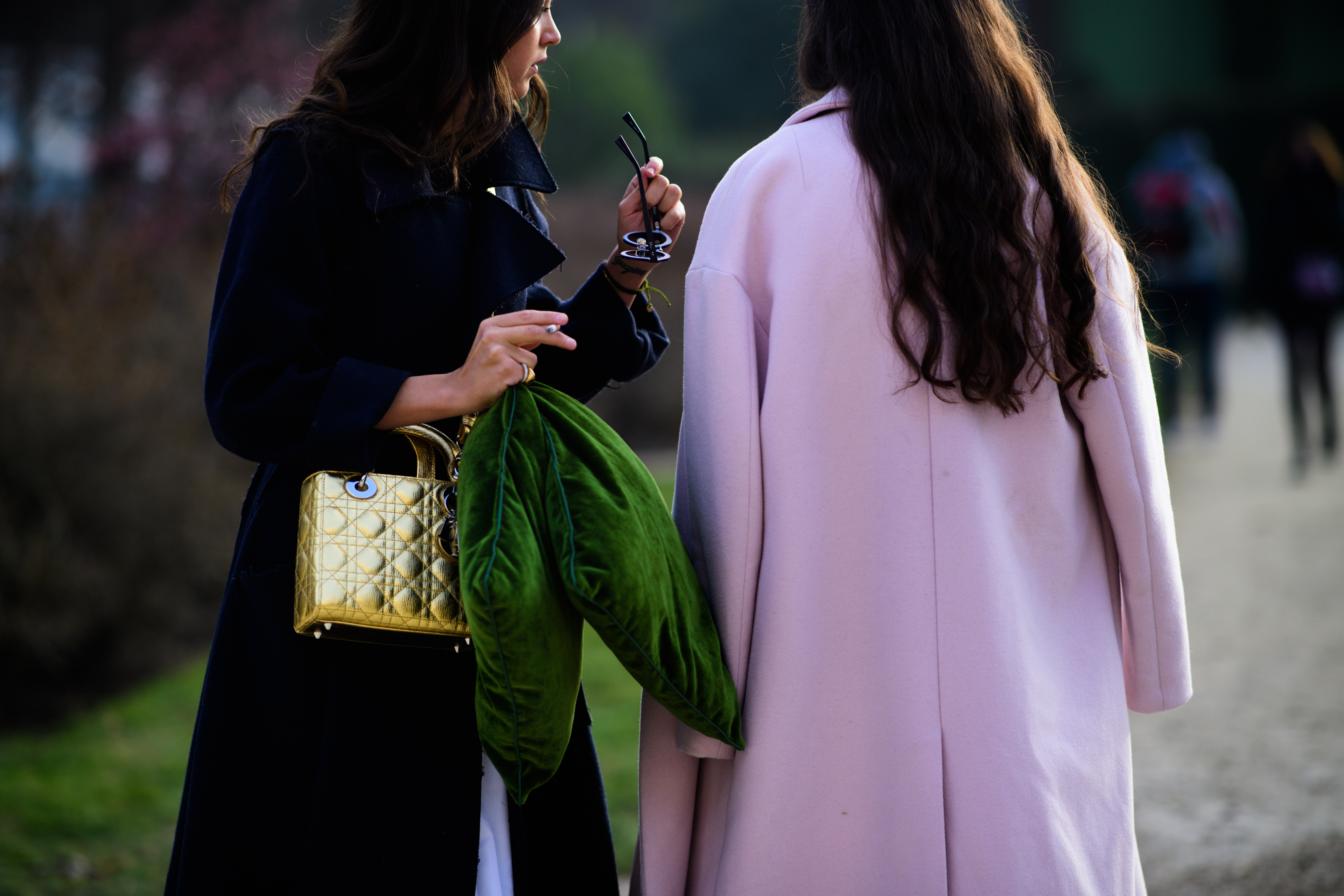 Woman with Cristian Dior golden handbag
