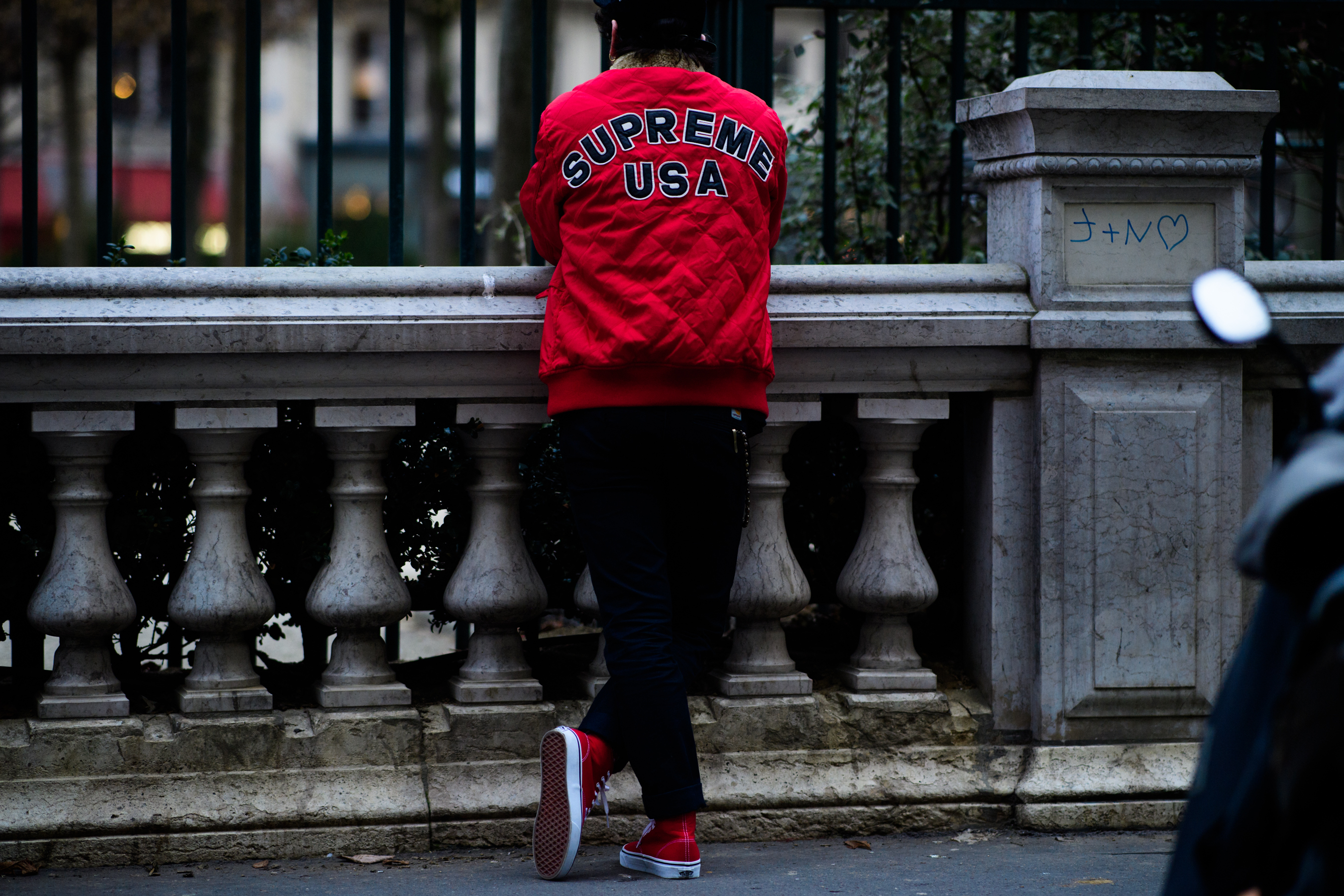 Man wearing supreme jacket and vans shoes