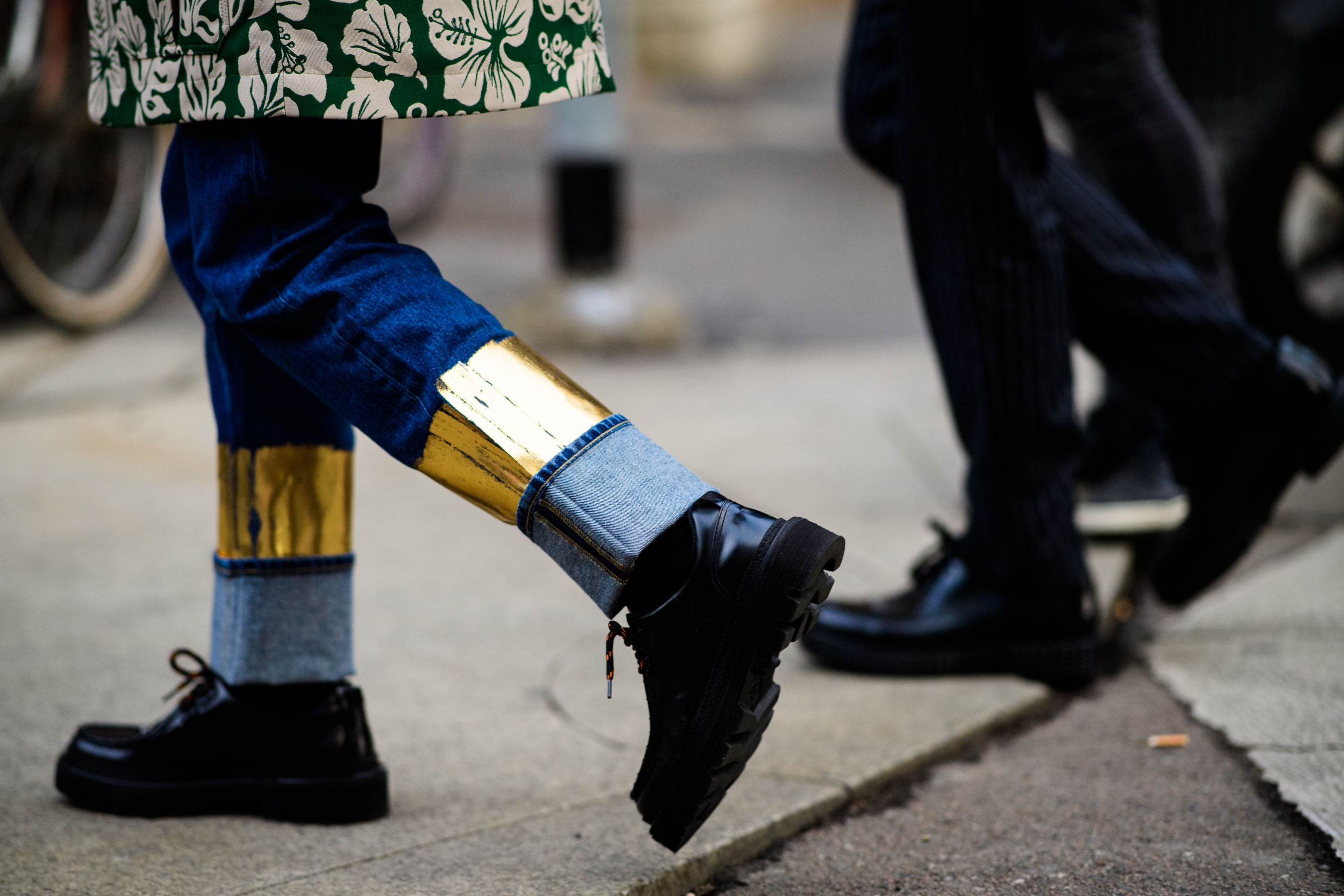 Asian man wearing golden denim pants