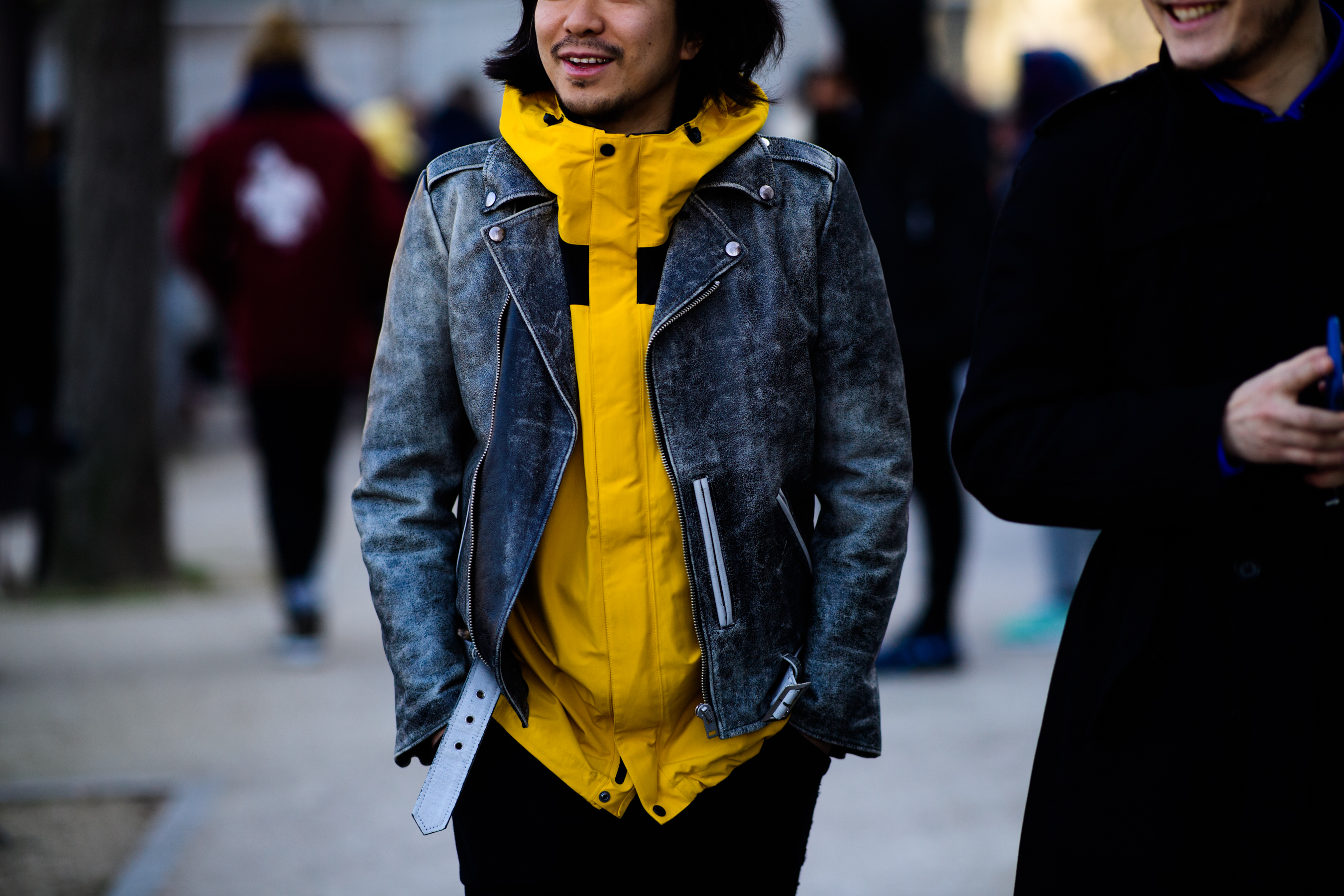 Man wearing yellow jacket under leather jacket