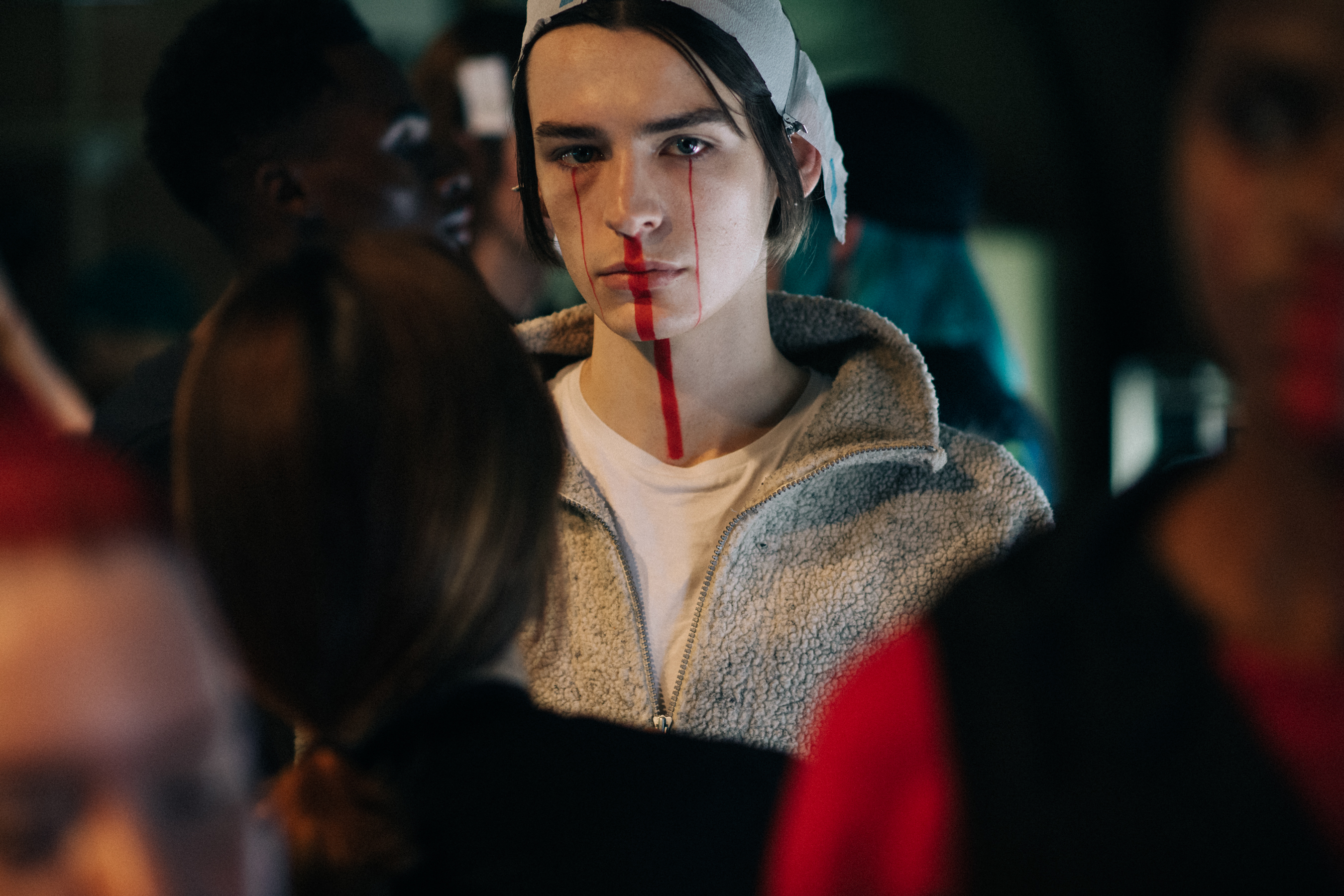 Male model wearing red makeup