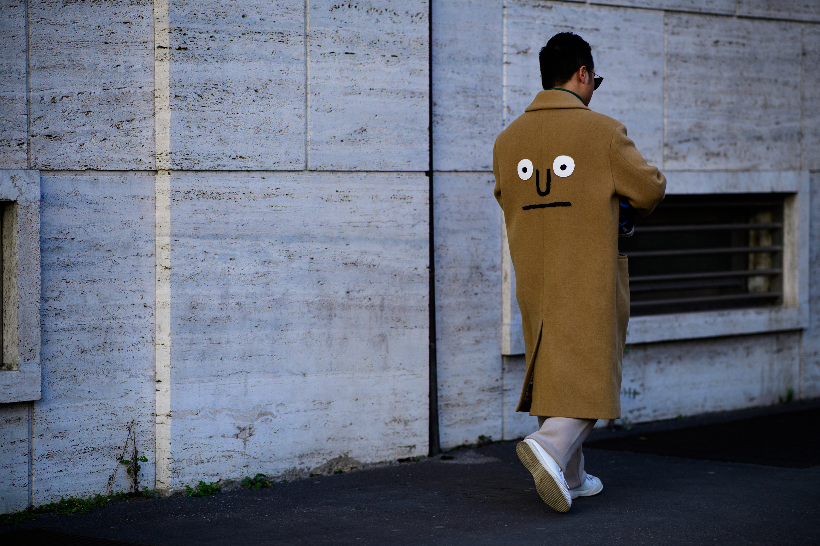 Man wearing coat with face