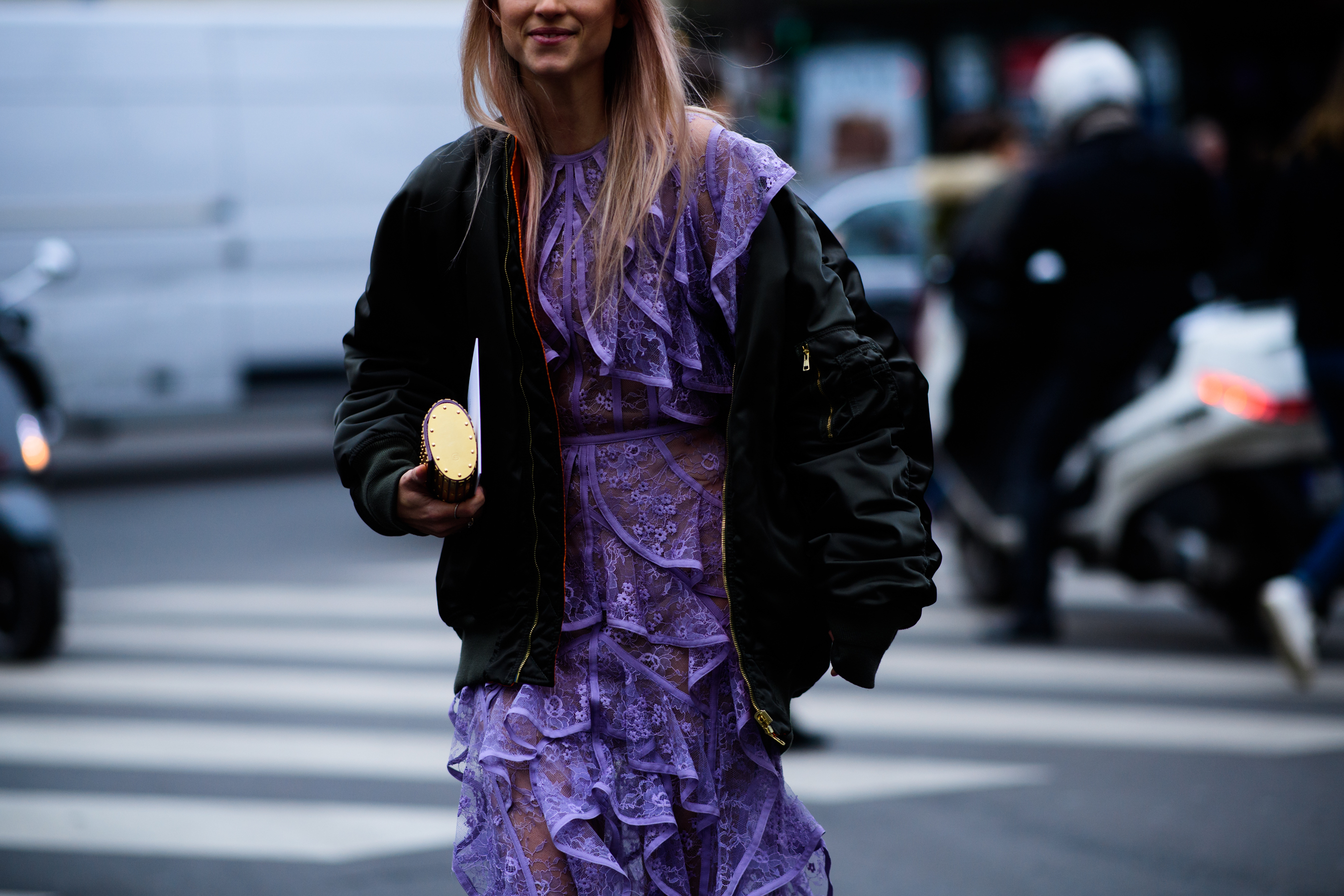 Woman wearing violet dress and vetements jacket