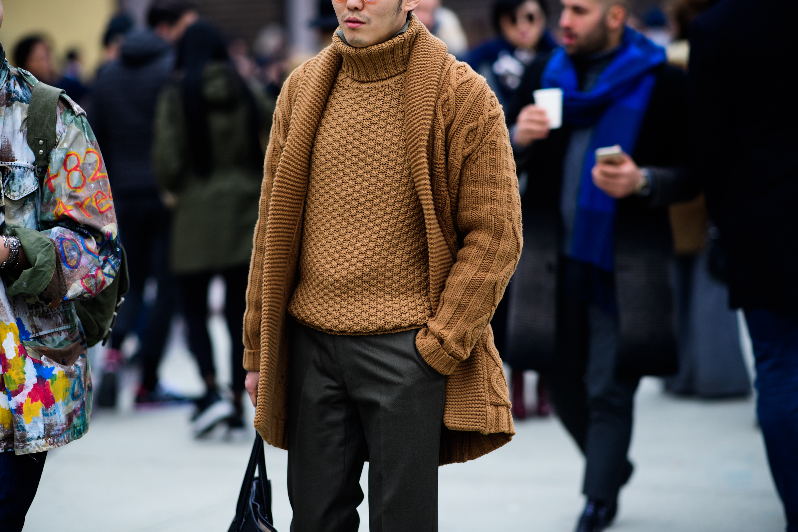 Asian man wearing brown sweater