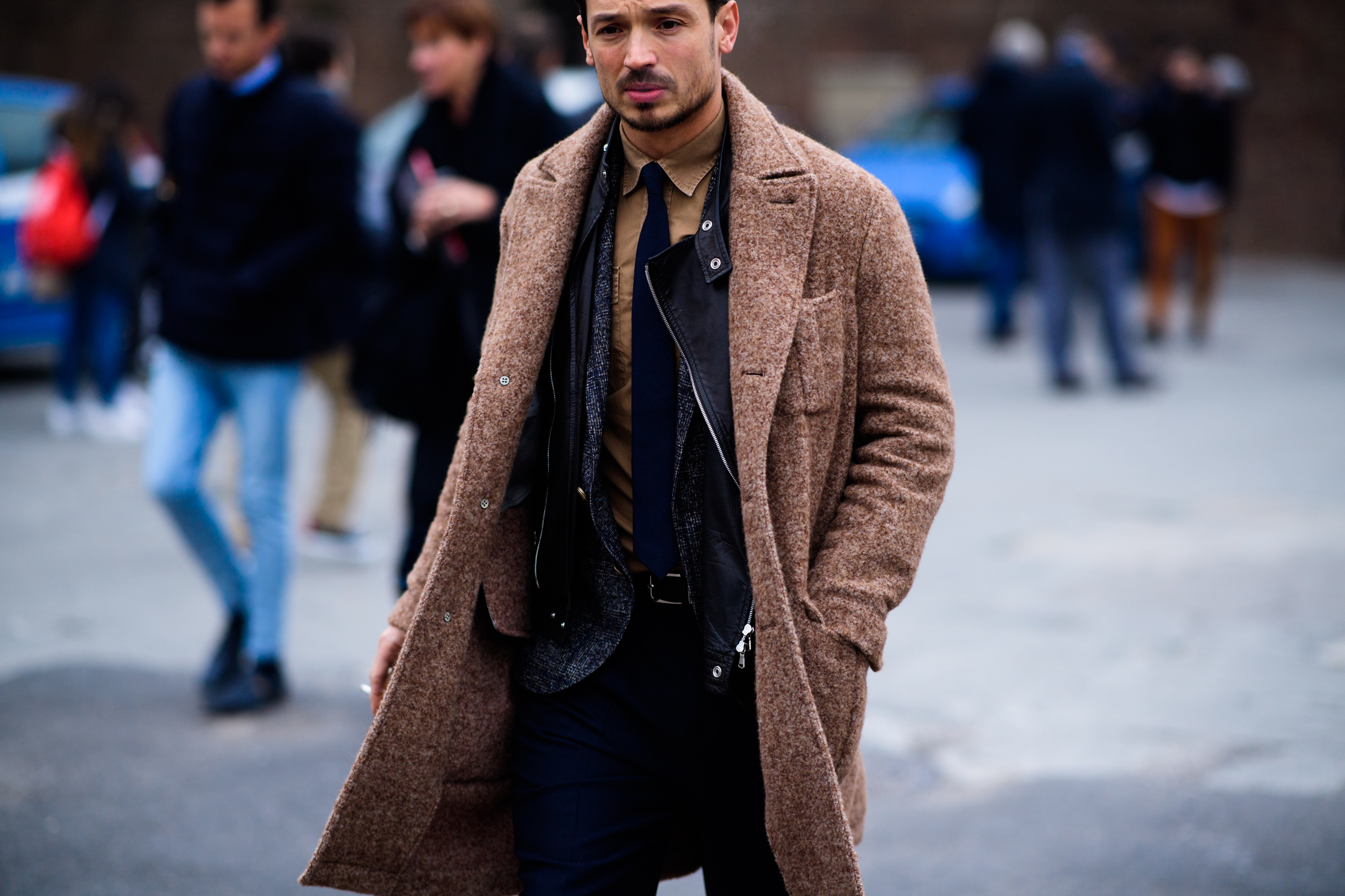 Man wearing leather jacket under coat