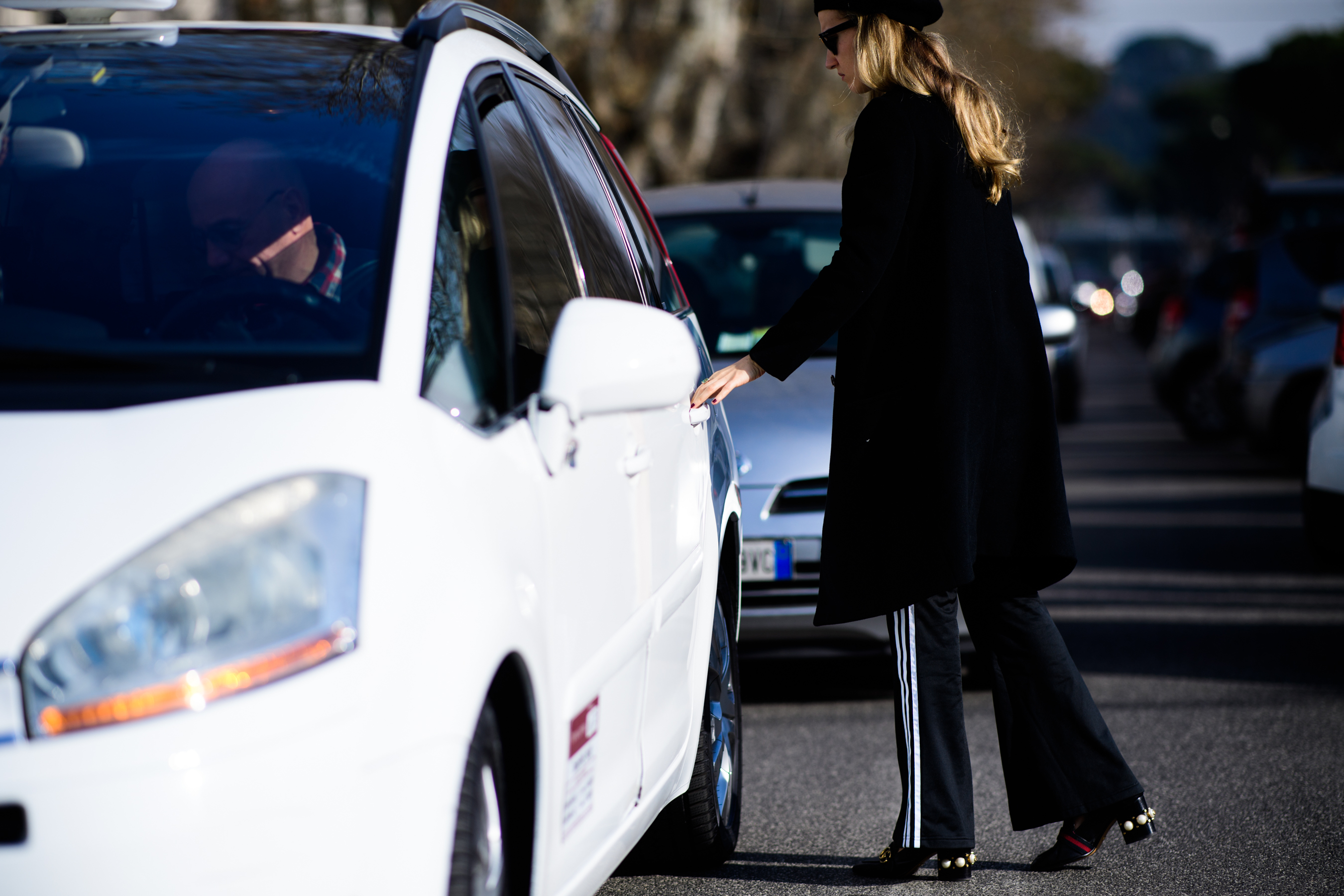 Woman wearing Adidas pants and Gucci shoes