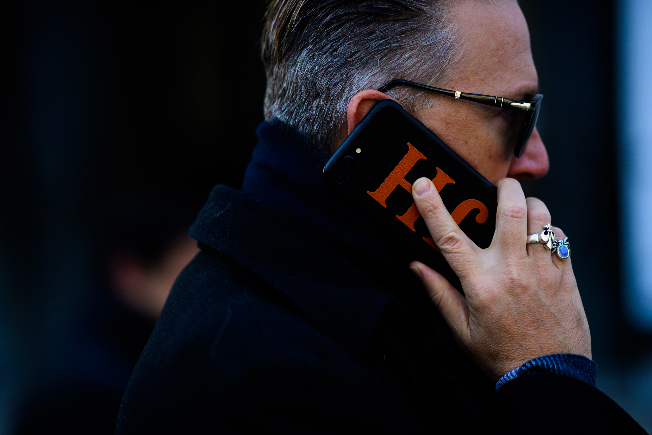 Man with JH logo on iphone case