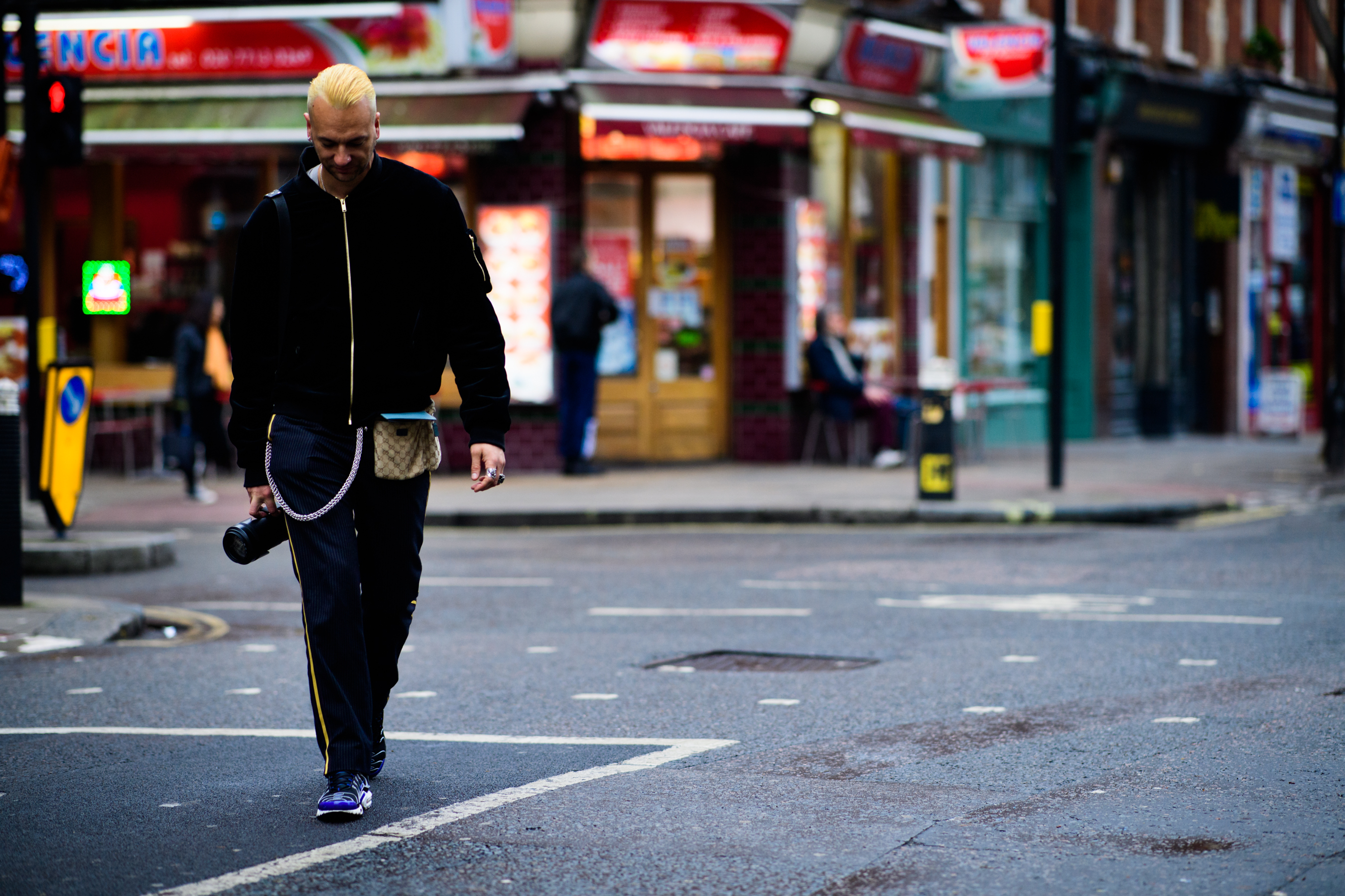 Man wearing Louis Vuitton bag