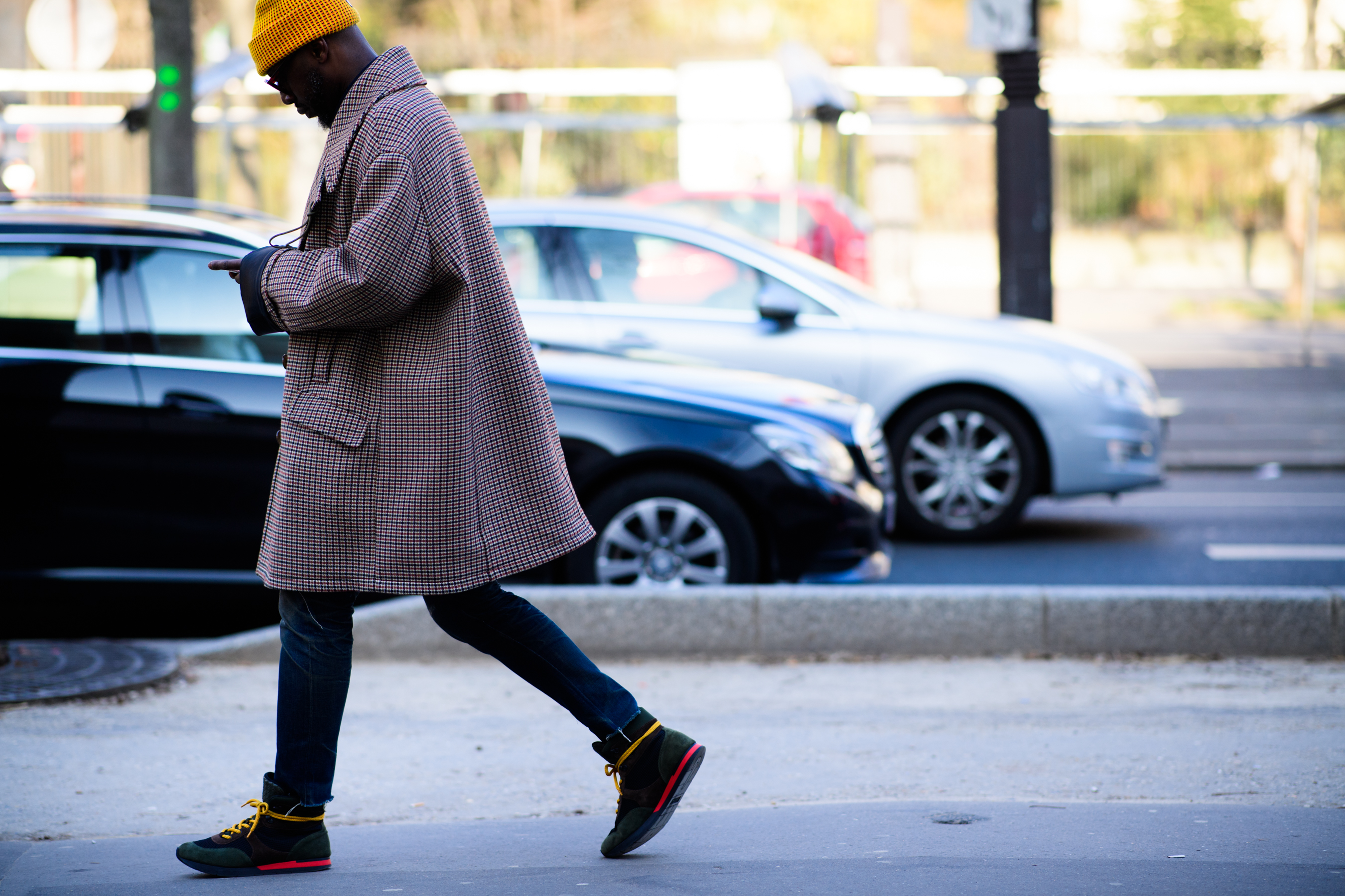 African man wearing Raf Simons coat