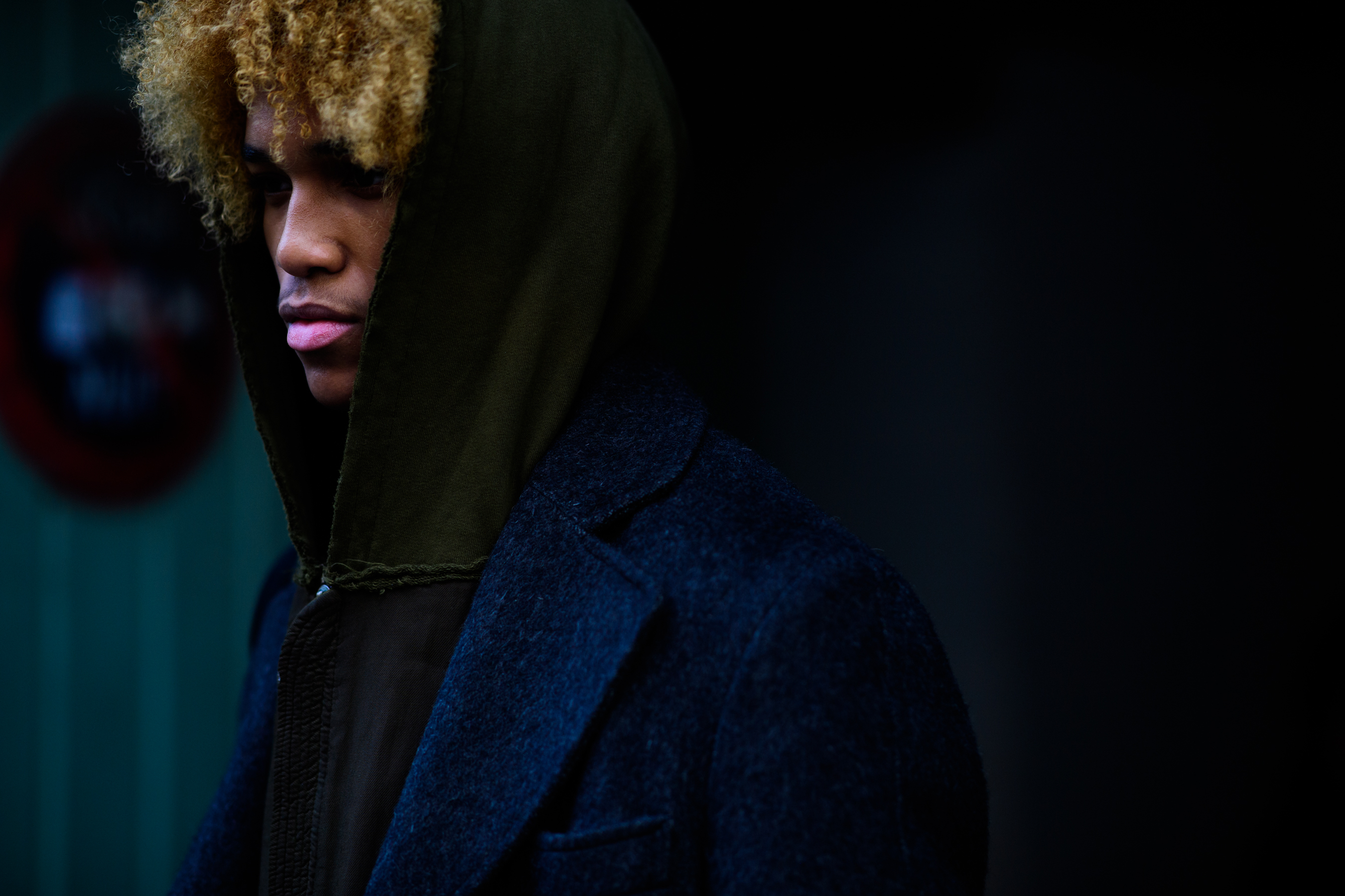 Man wearing hoodie under coat