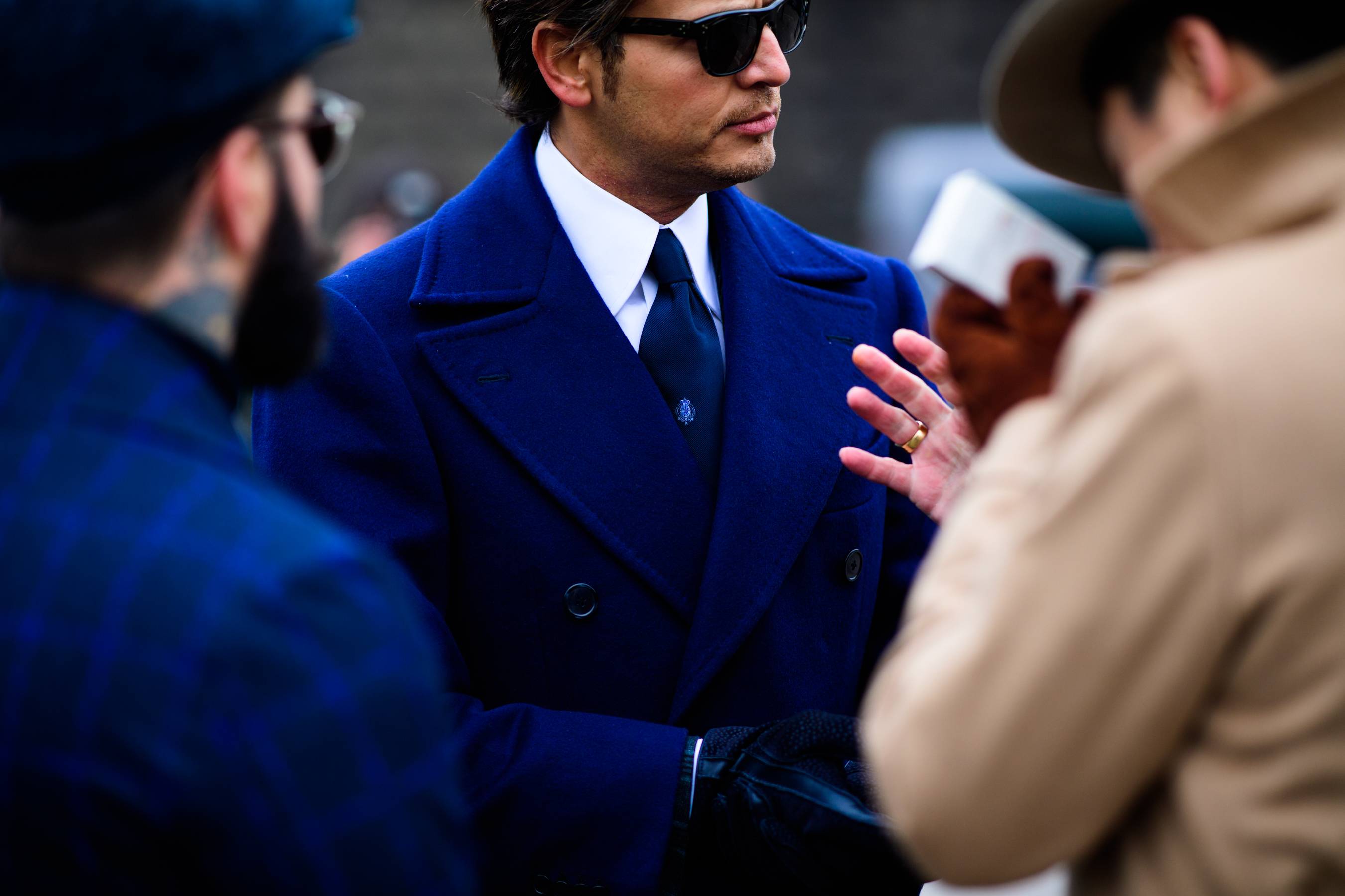 Man wearing shirt and tie under blue coat