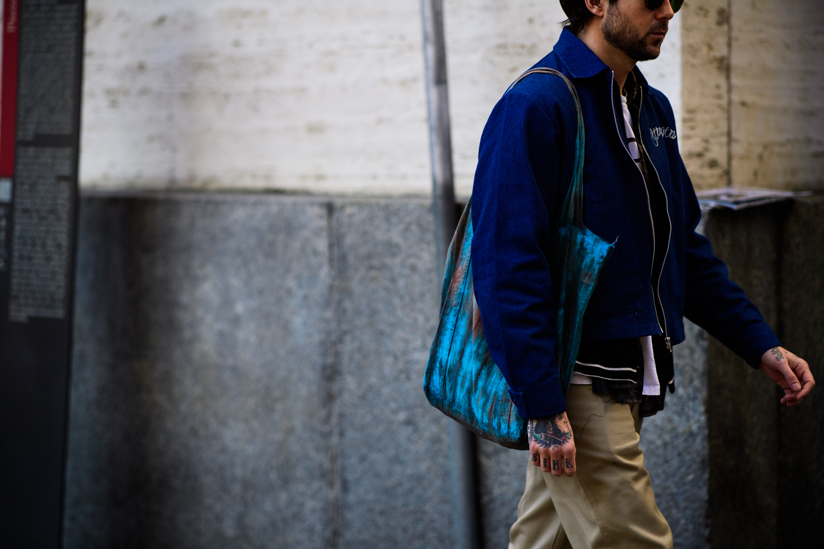 Man with blue handbag