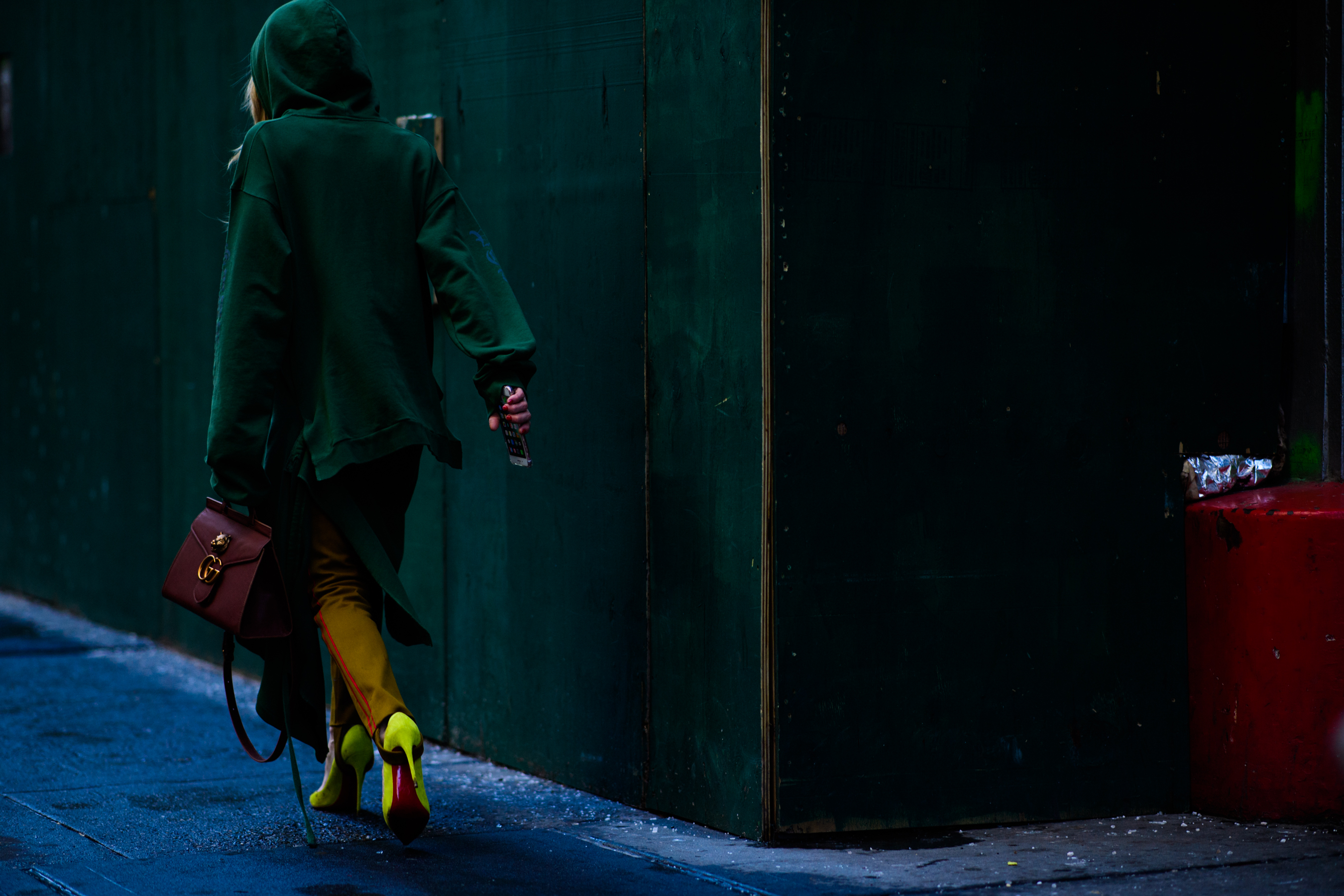 Woman wearing green clothes and Gucci handbag