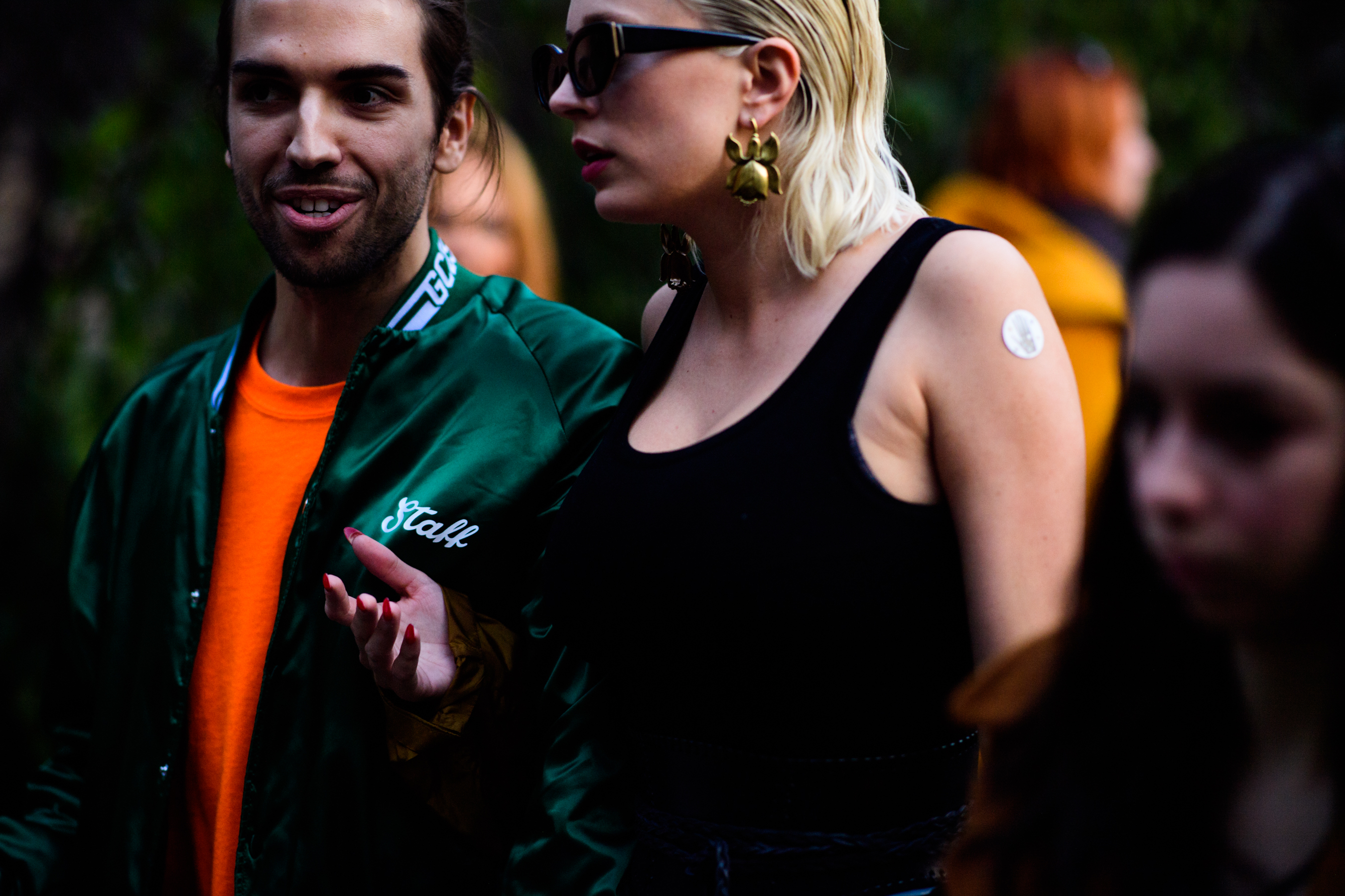 Man wearing orange sweater and green jacket