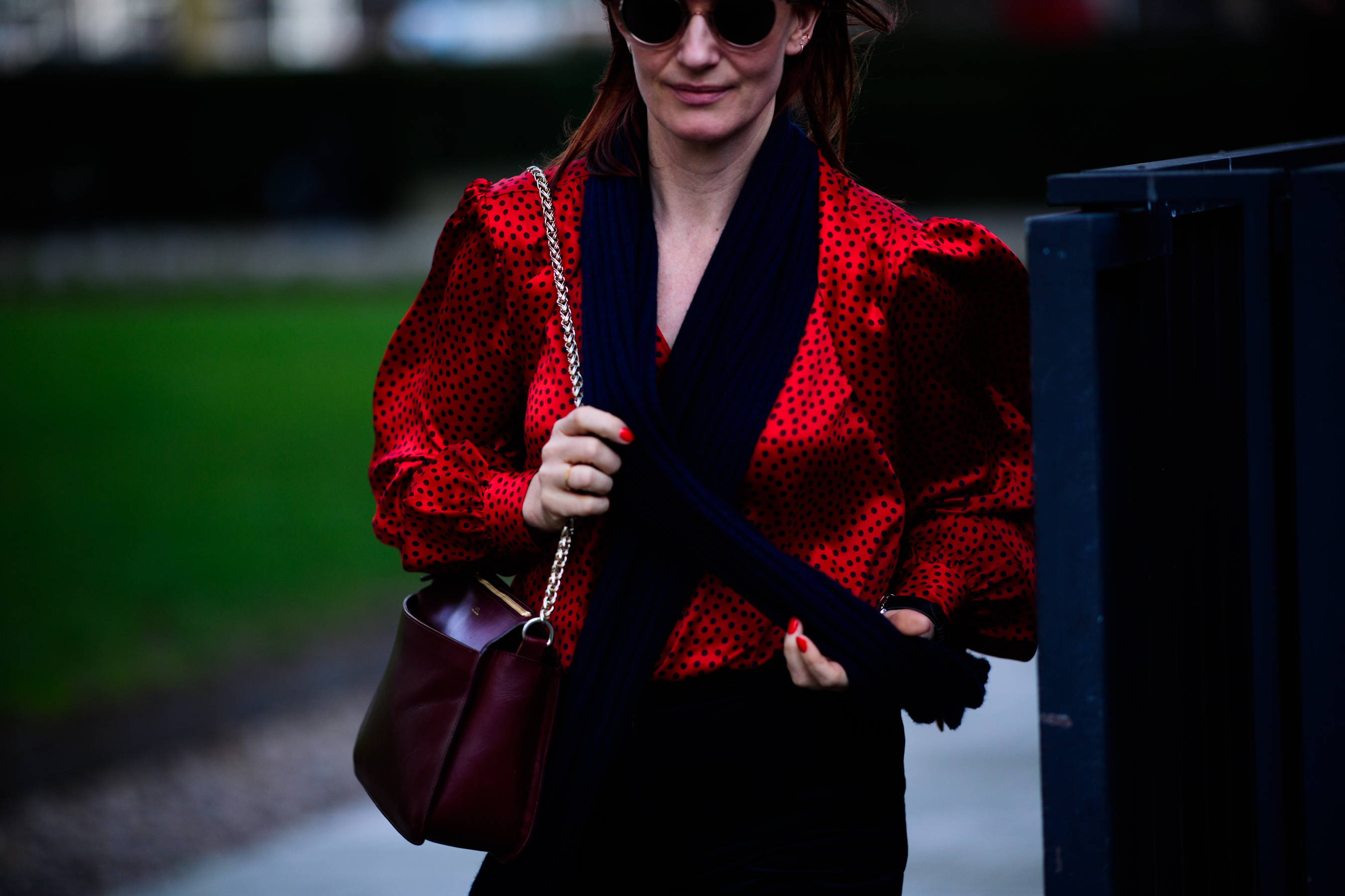 Woman wearing bright red silk blouse