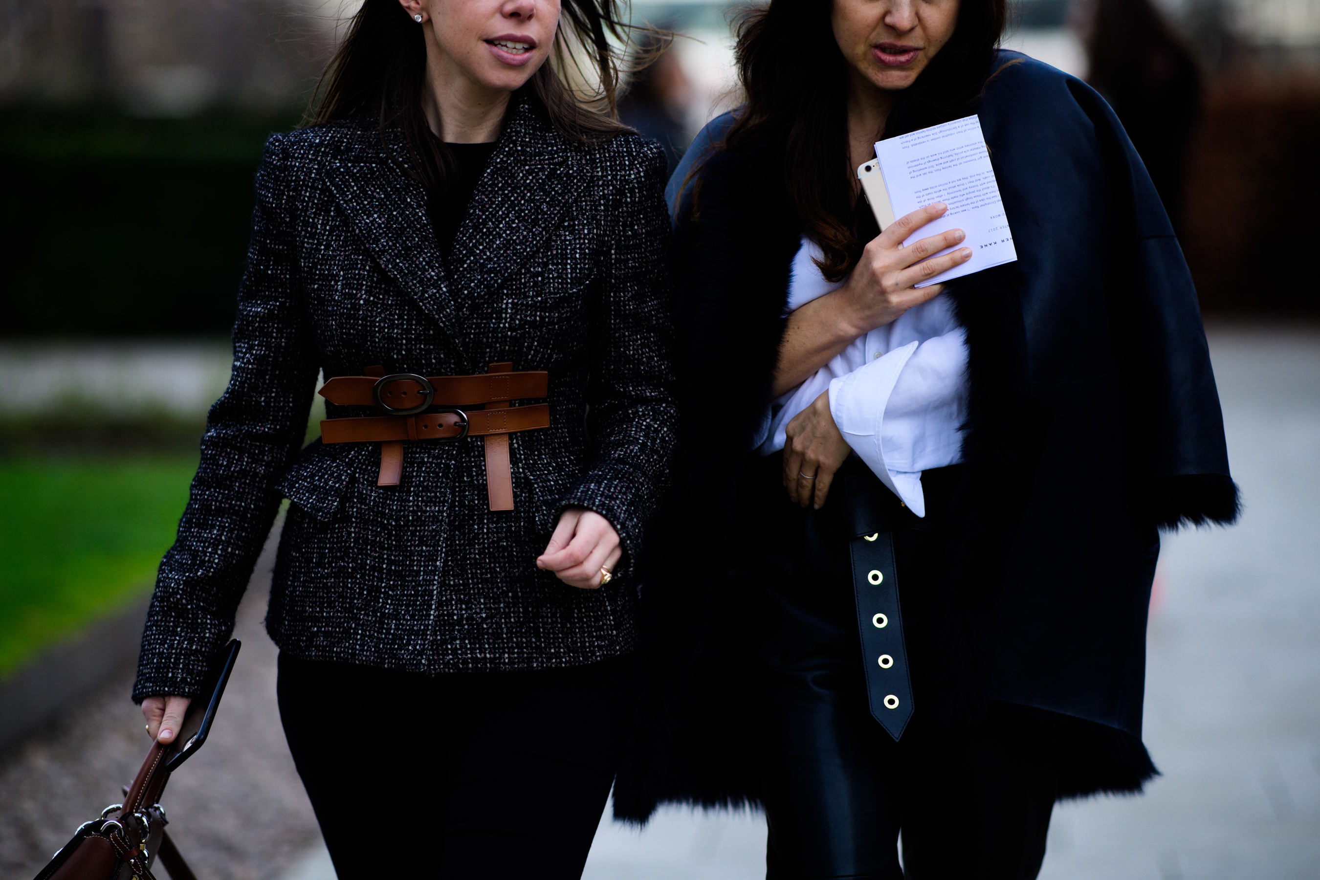 Two women with belted outfits