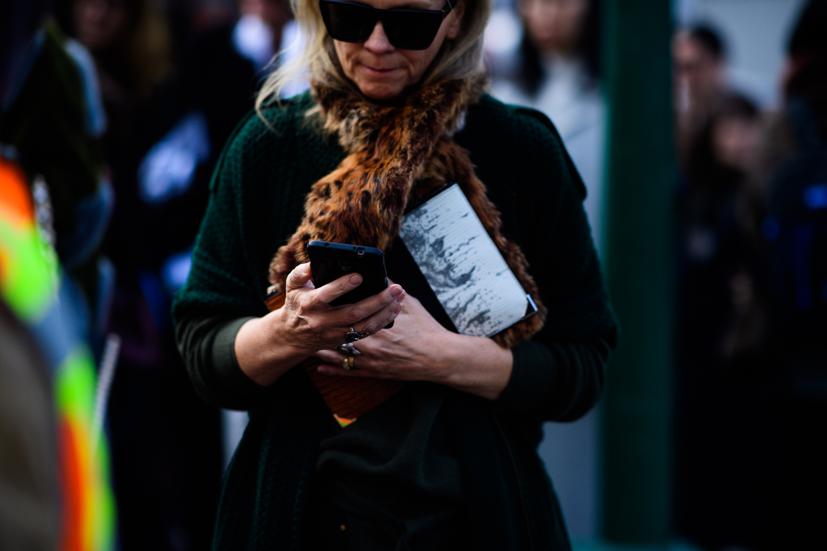 Woman wearing green clothes and fur scarf