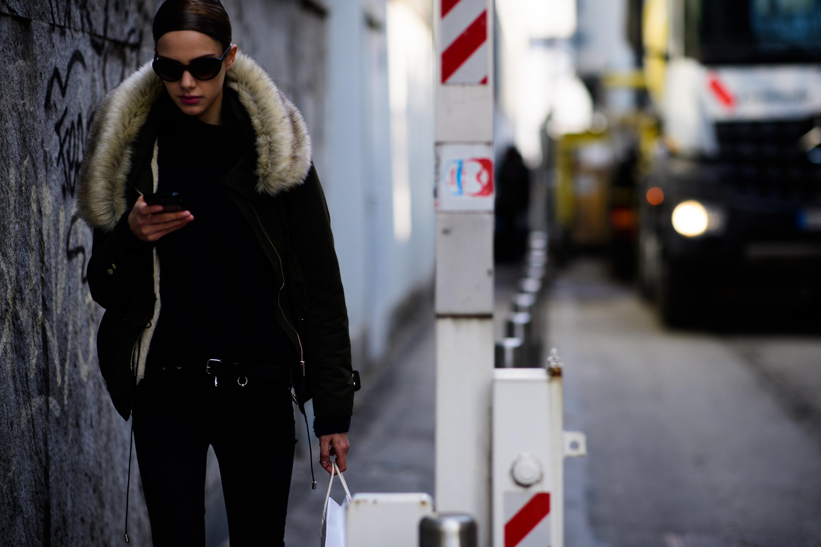 Model wearing jacket with fur hood