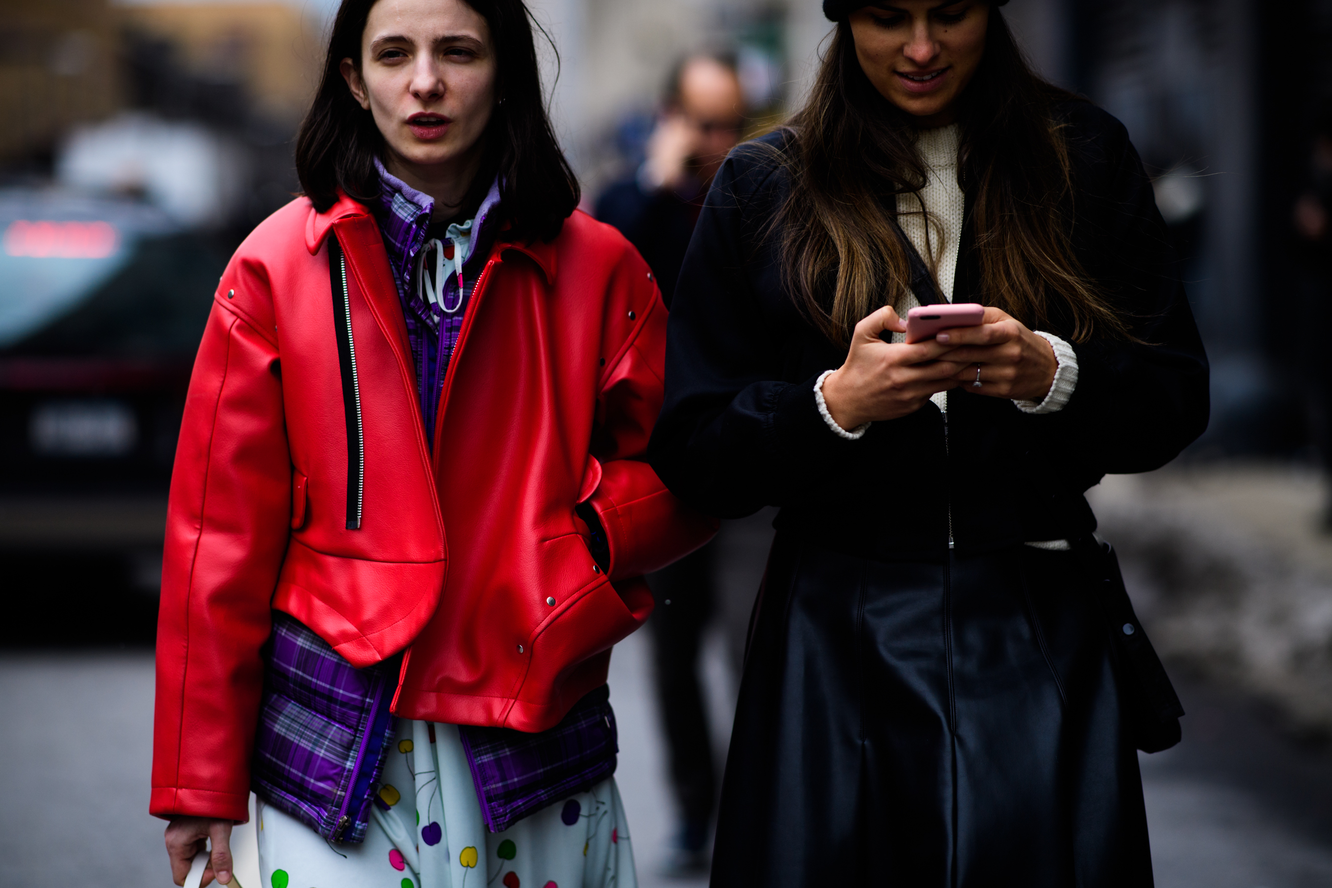Two women wearing bomber jackets