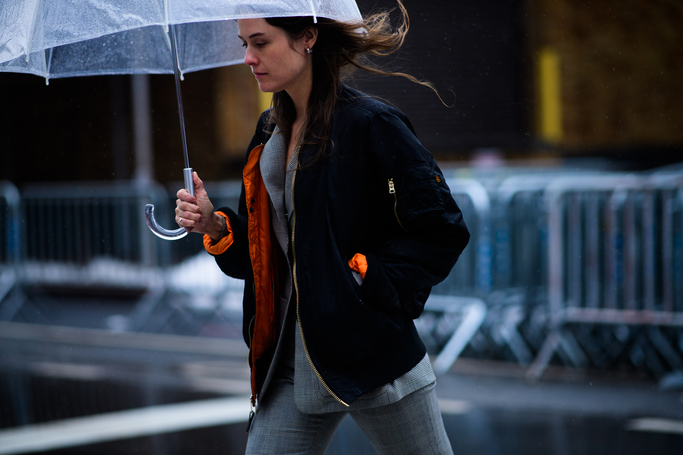Woman wearing bomber over grey suit