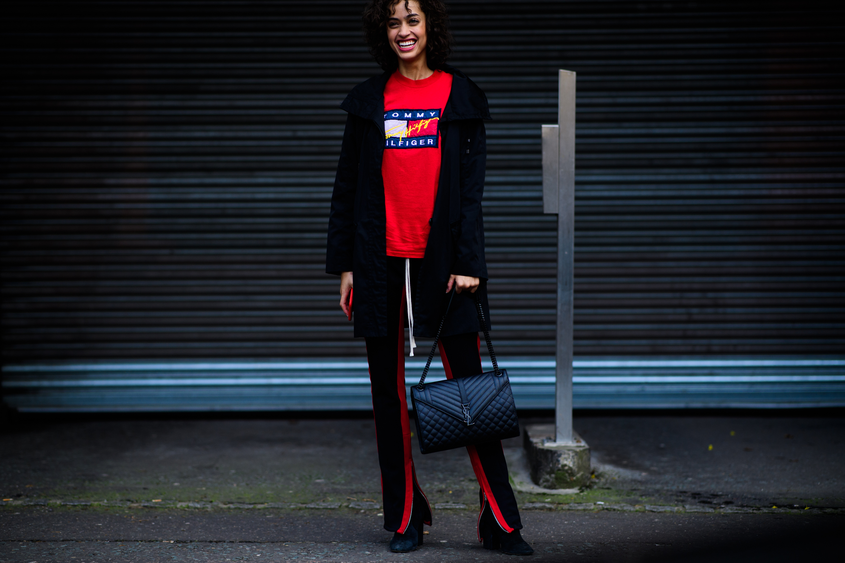 Woman with Saint Lauren handbag wearing Tommy Hilfiger sweater