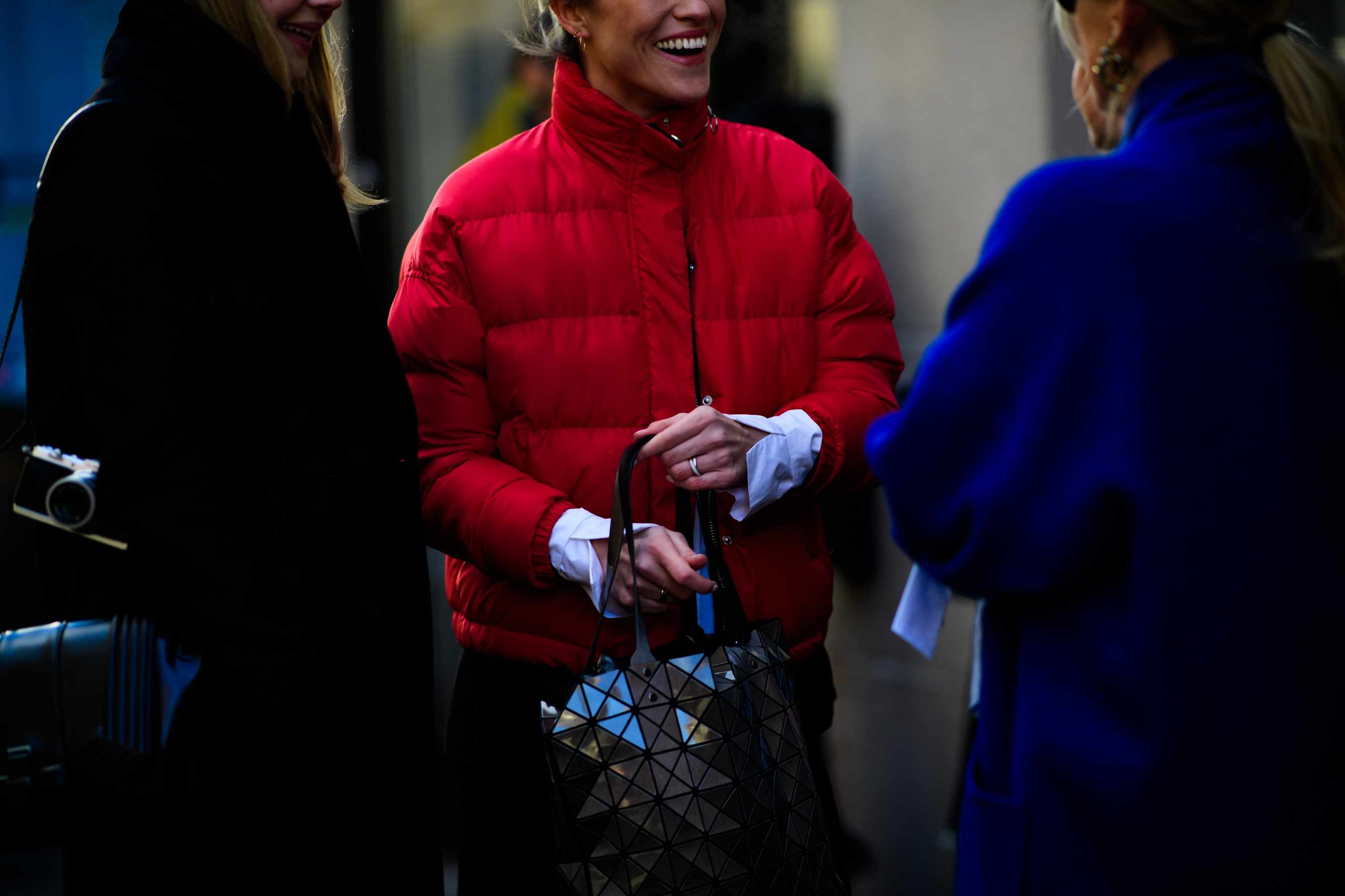 Woman wearing white shirt under red jacket
