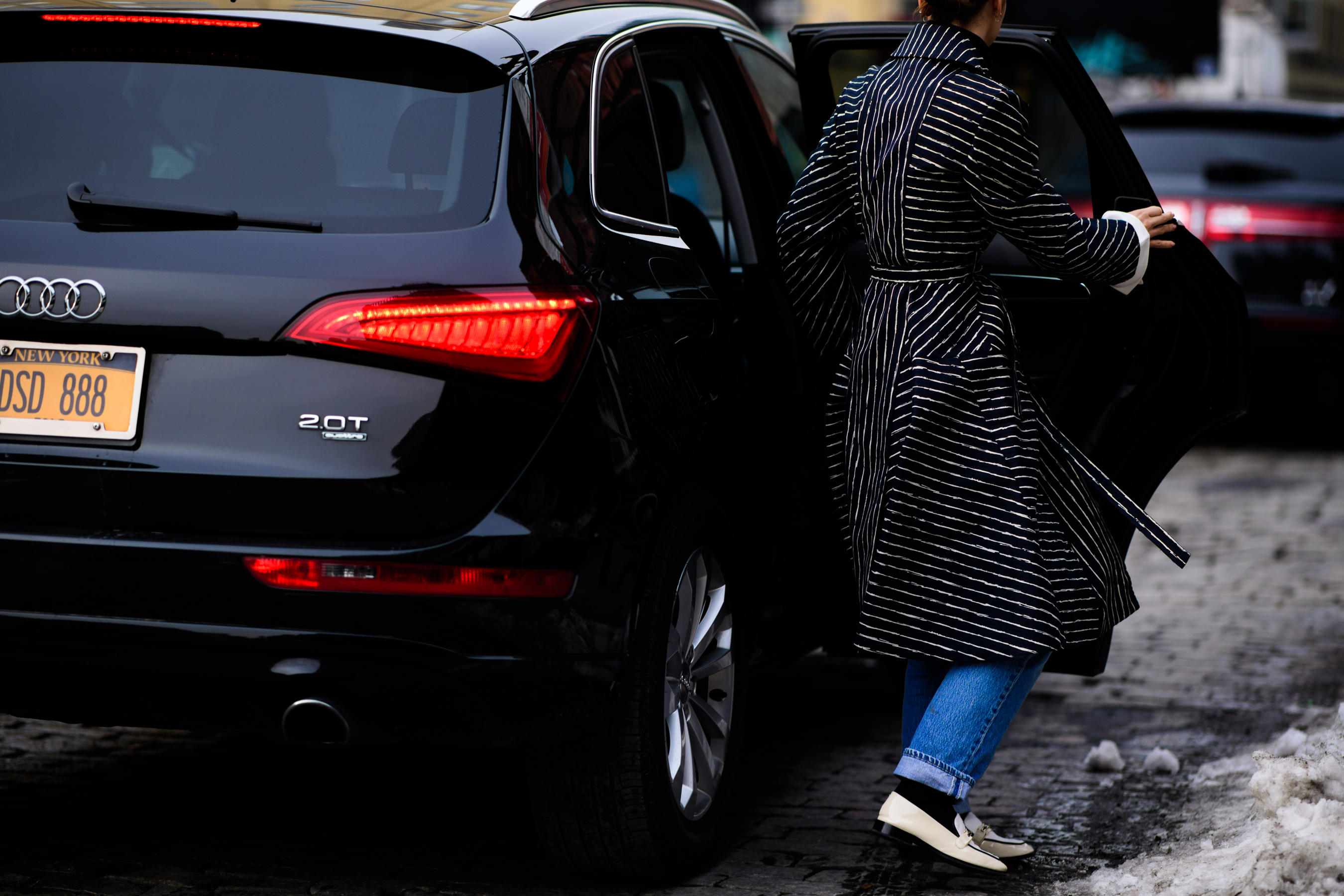 American stylist wearing black coat