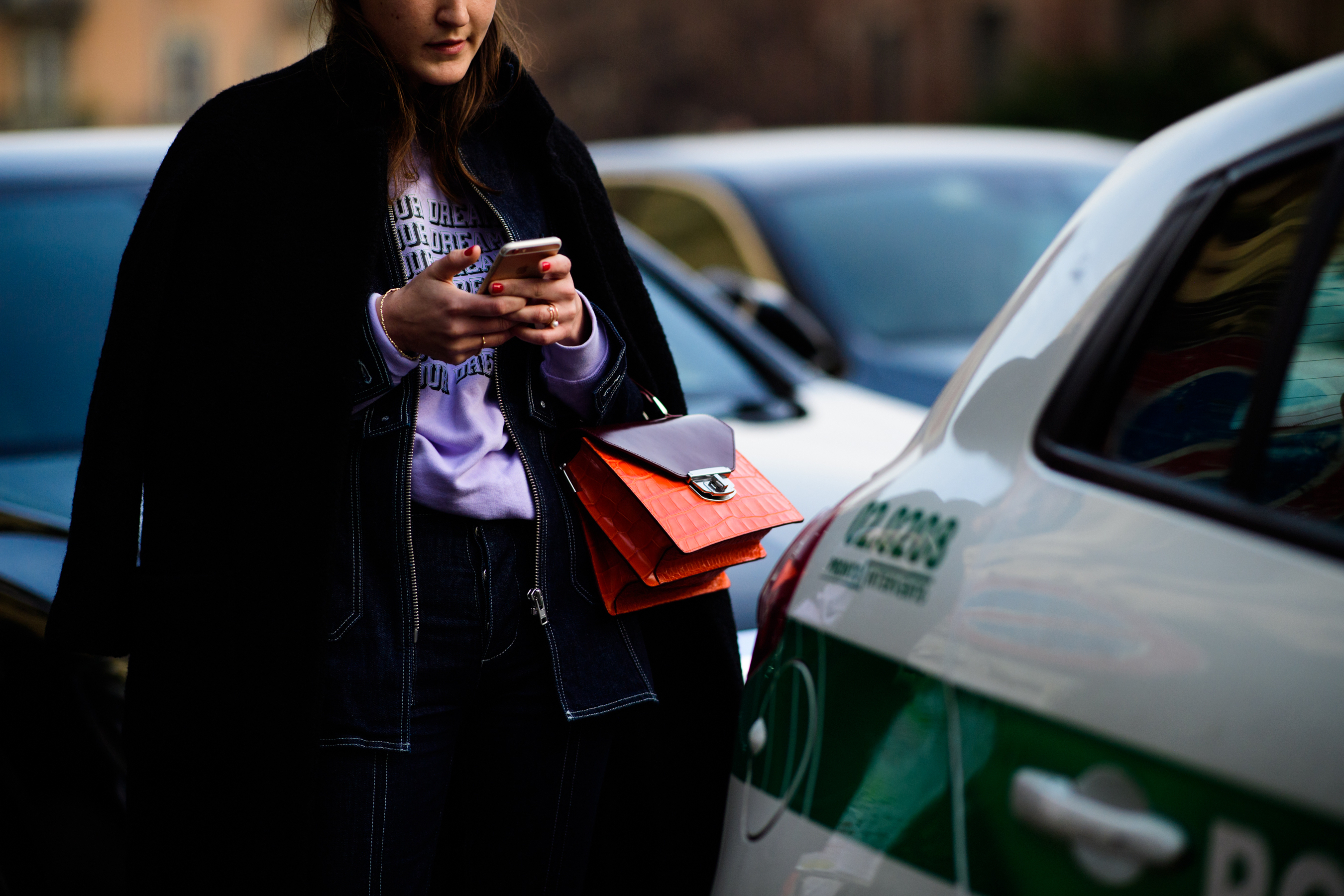 Woman wearing pink sweater and denim