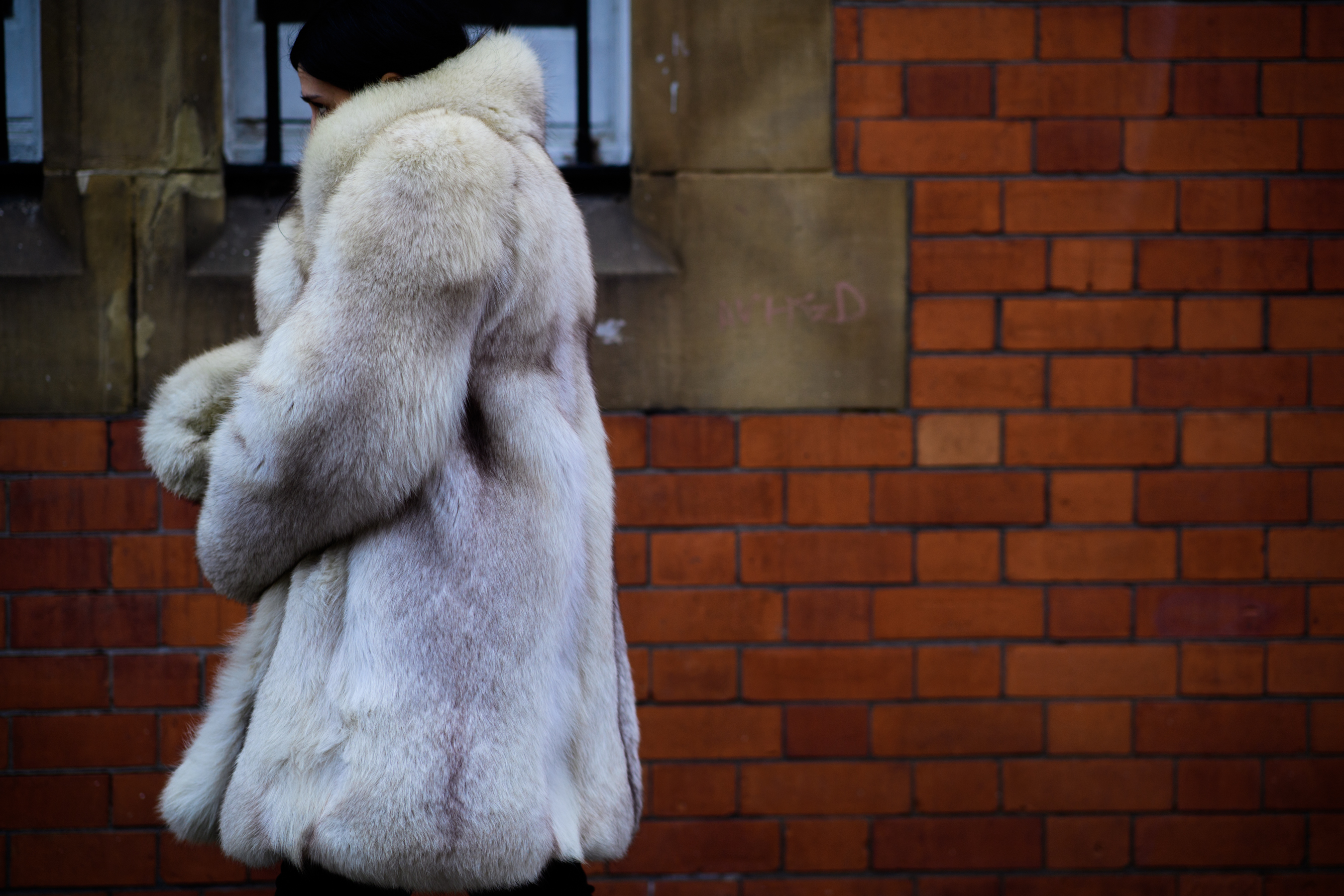 Woman wearing fur white coat