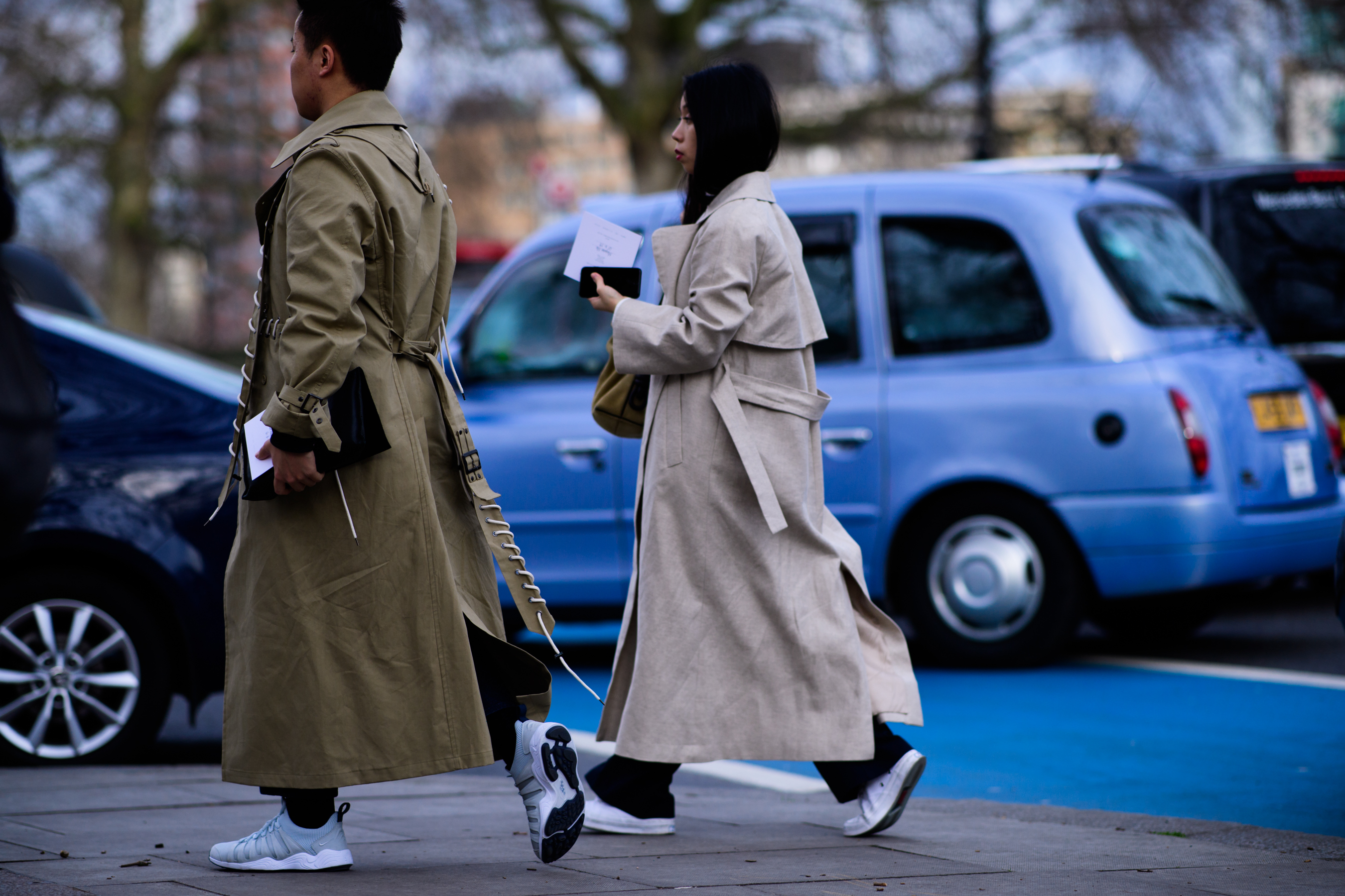 Man and woman wearing beige coats