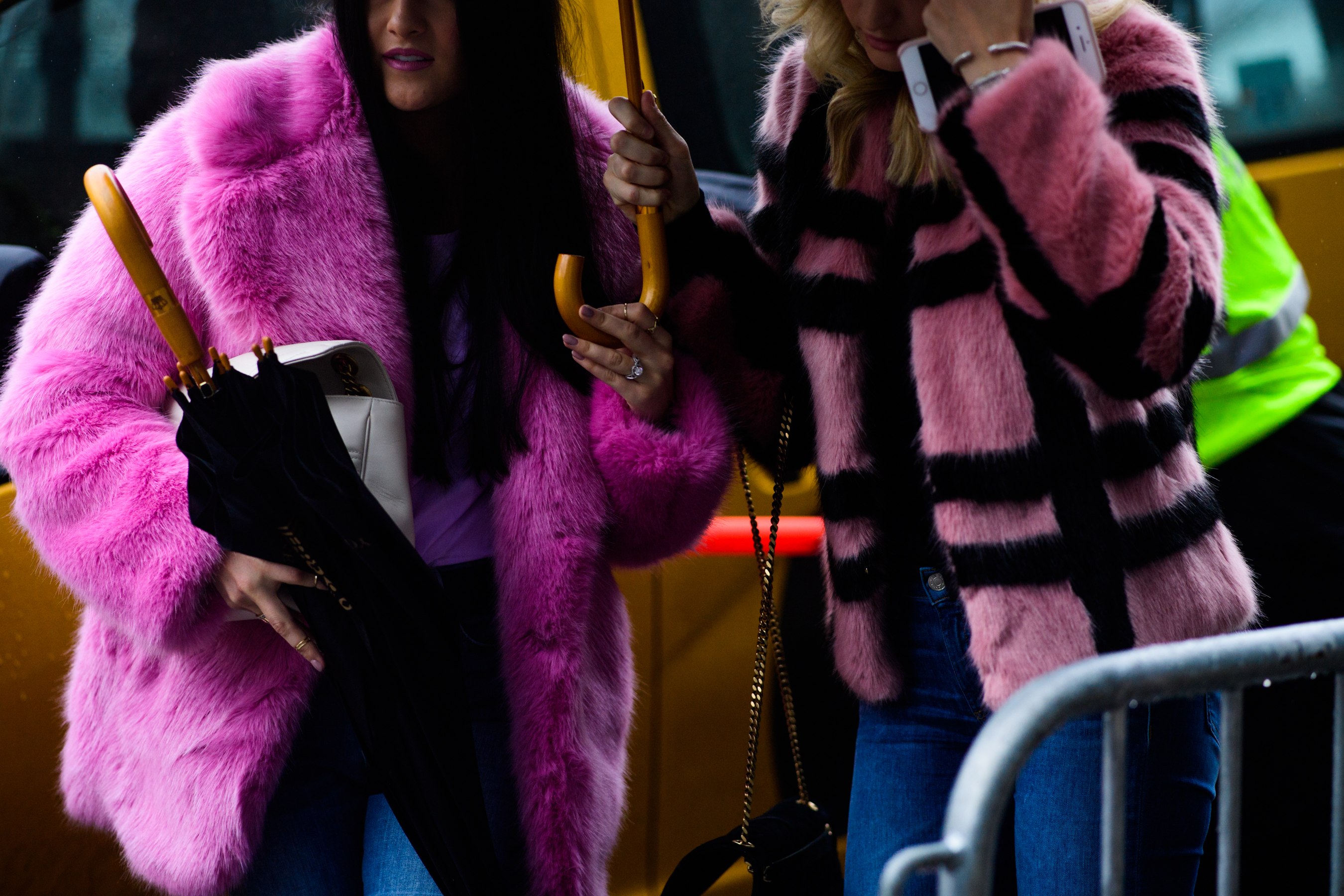 Two women wearing pink furcoats