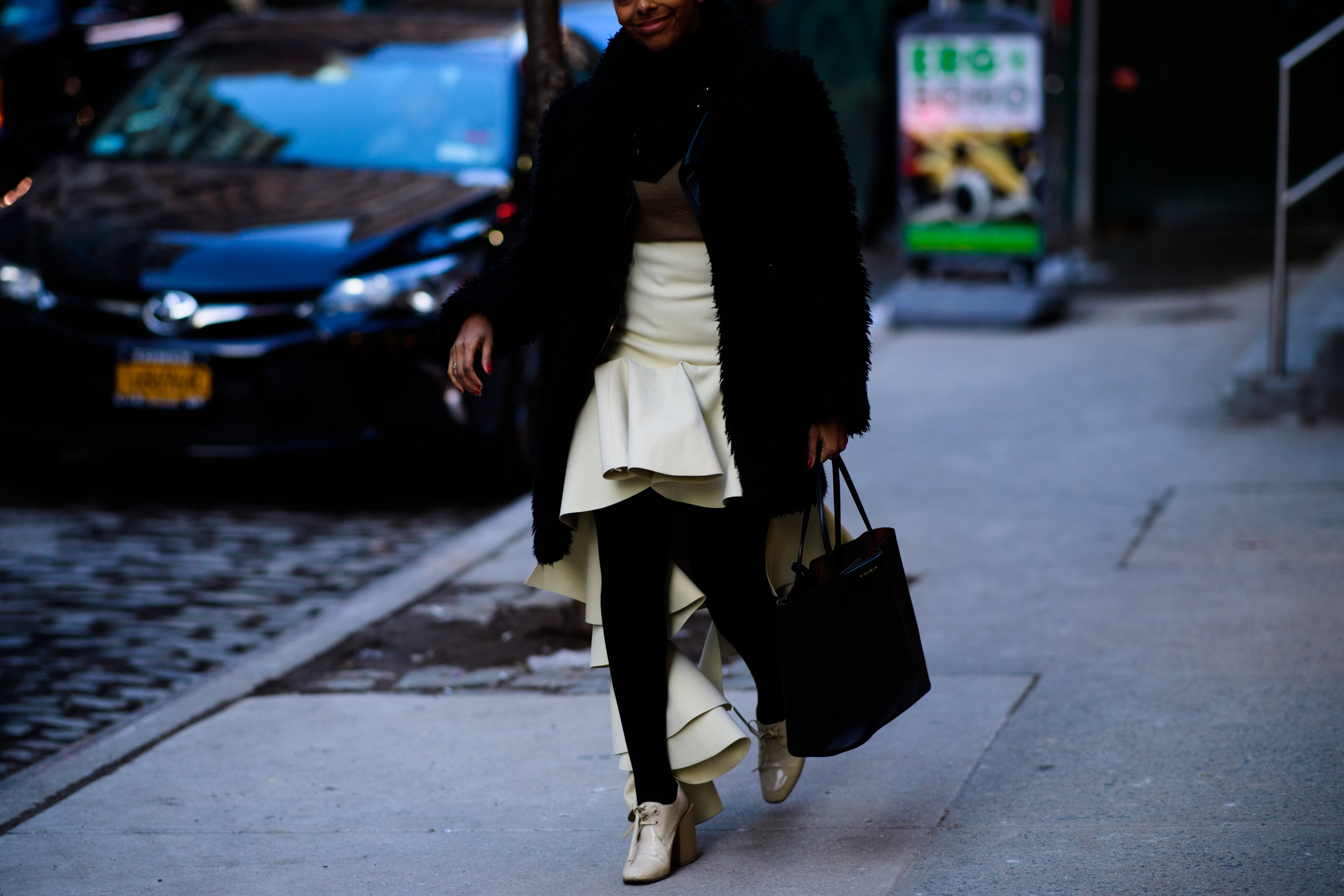 Woman wearing black clothes and white dress