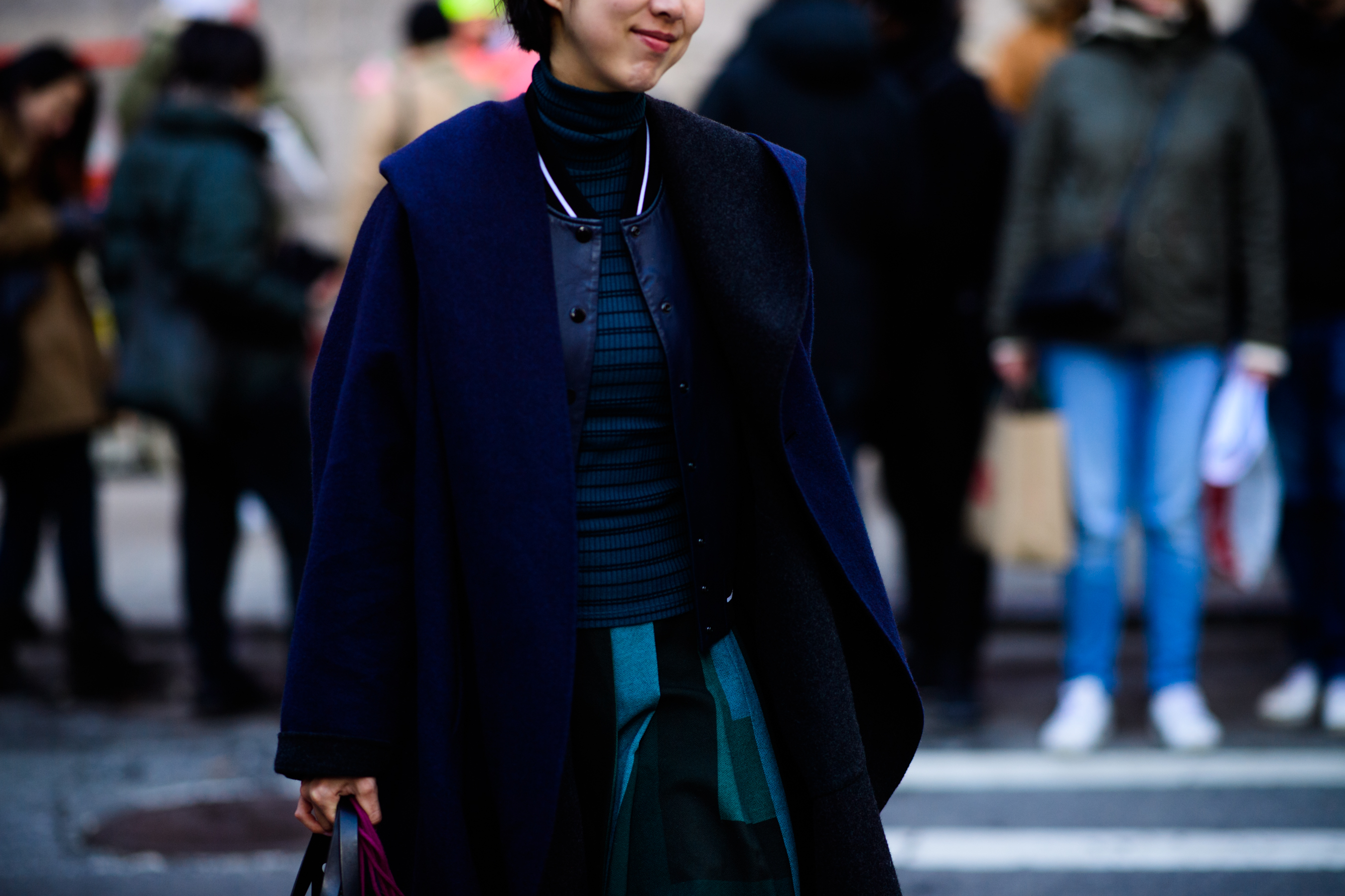 Woman wearing blue bomber under jacket