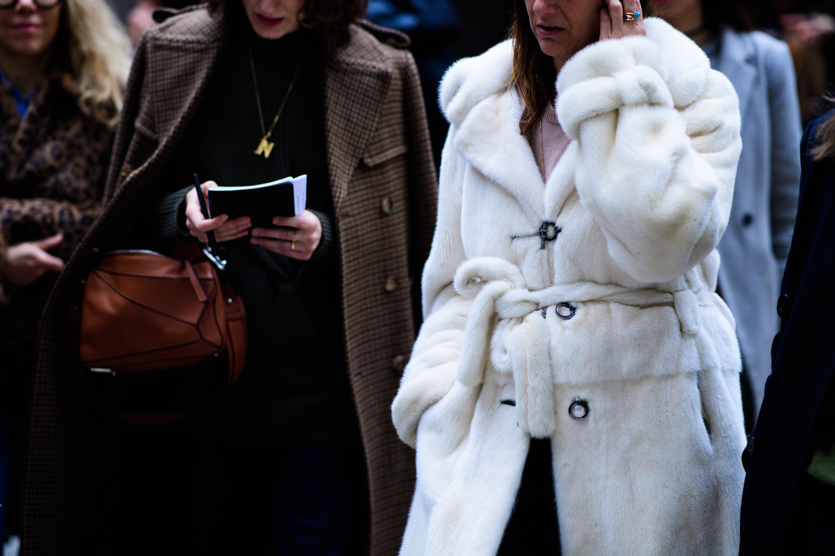 Woman wearing white fur coat