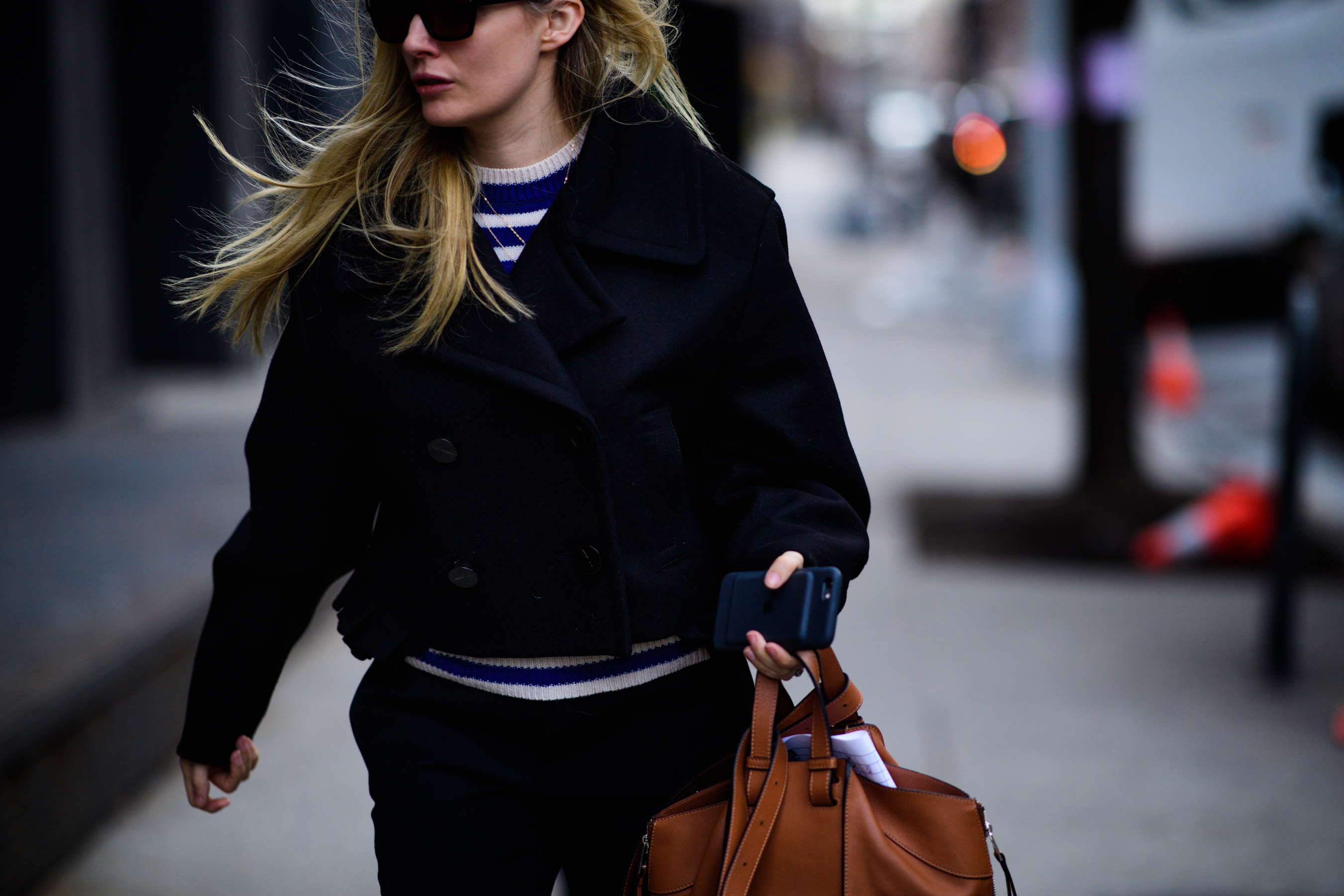 Woman wearing short black coat
