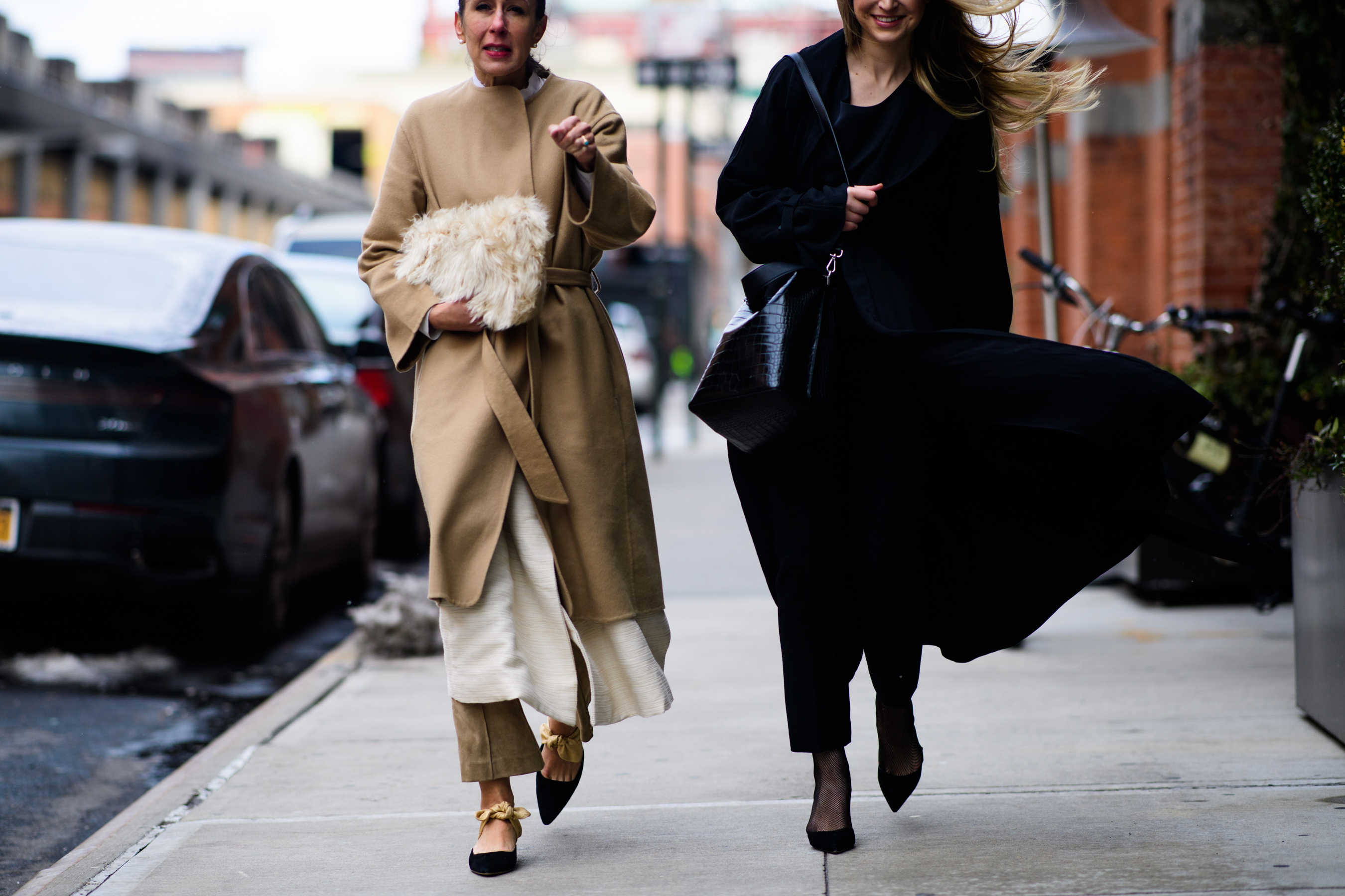 Two women wearing coats