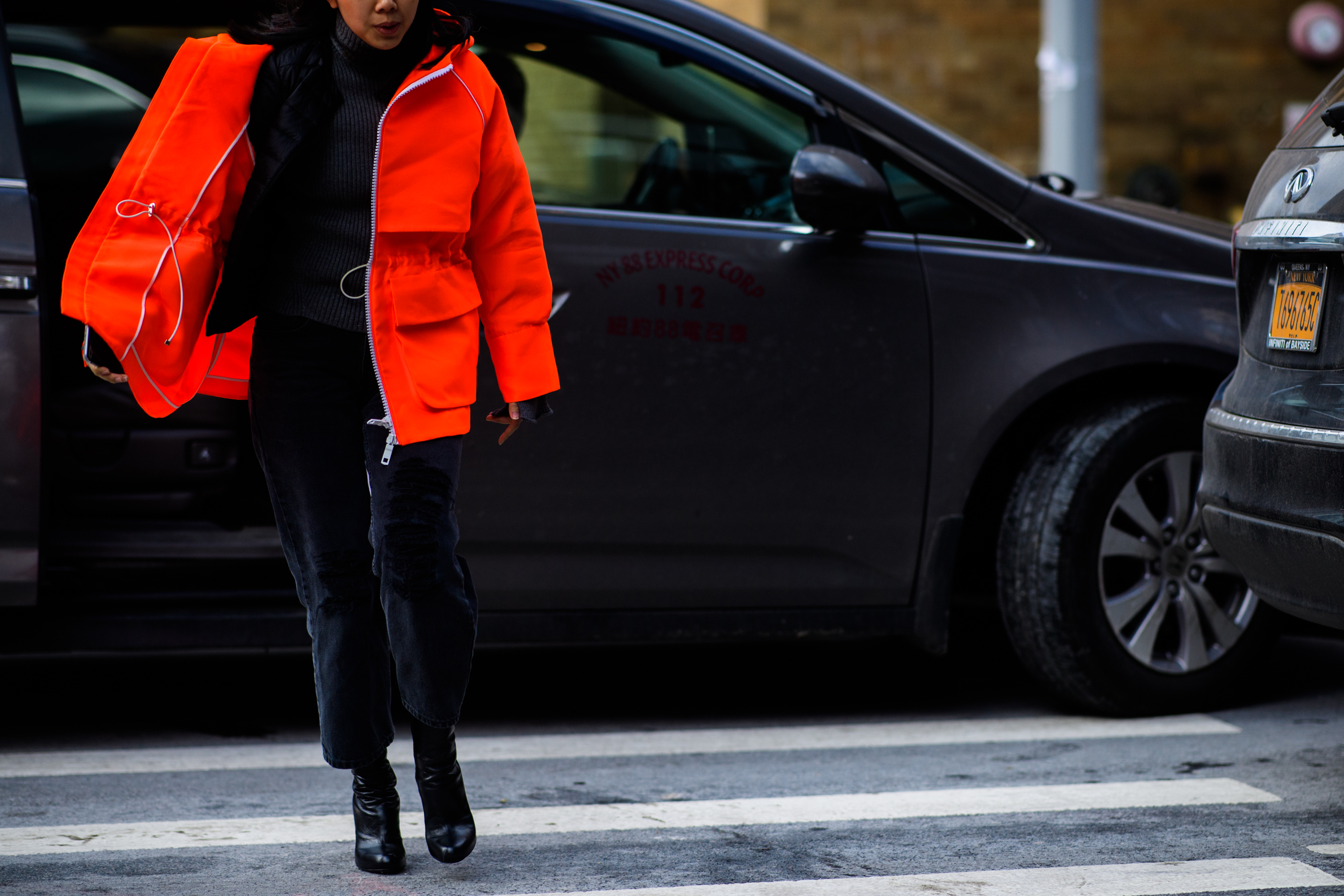 Woman wearing bright orange jacket