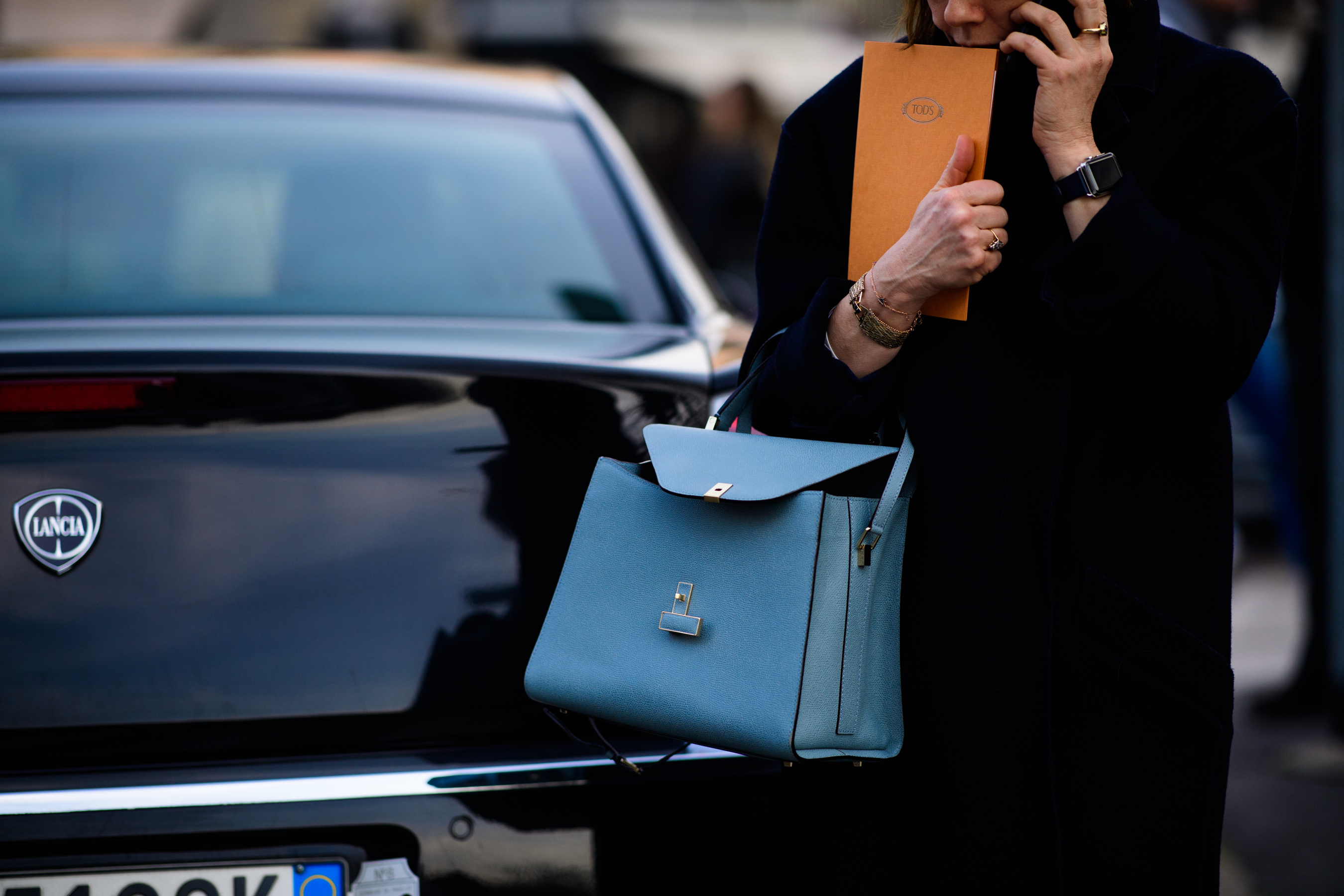 Woman wearing blue bag