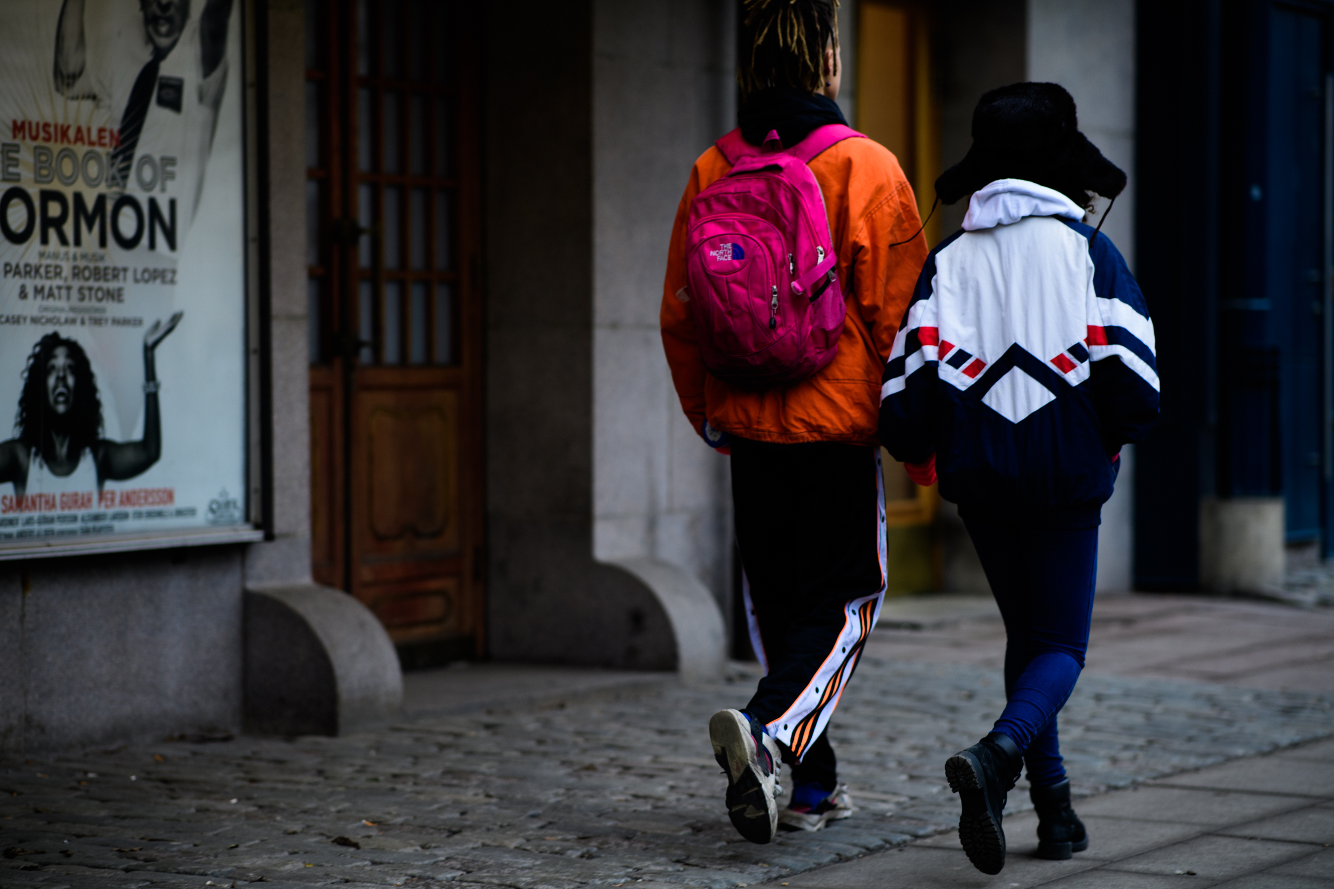 Man wearing pink The North Face backpack