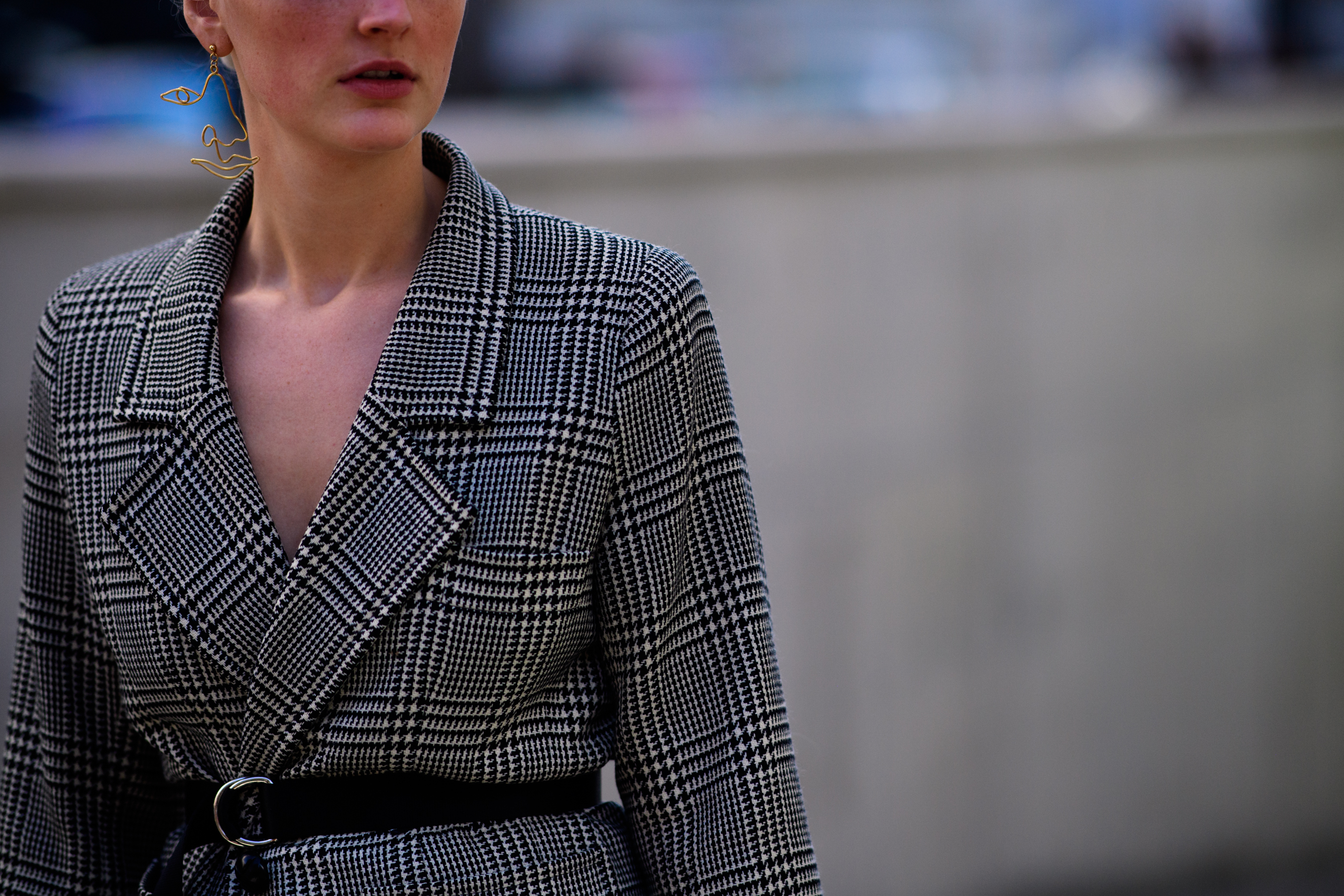 Woman with mono earring wearing blazer