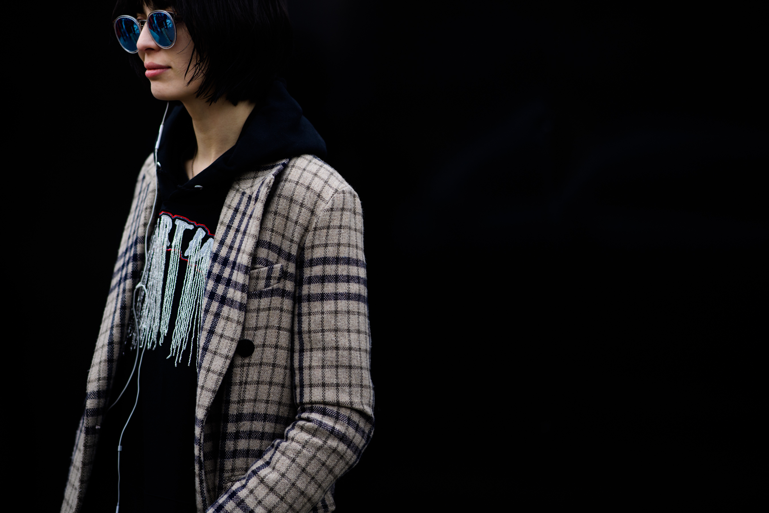 Woman wearing black hoodie under coat
