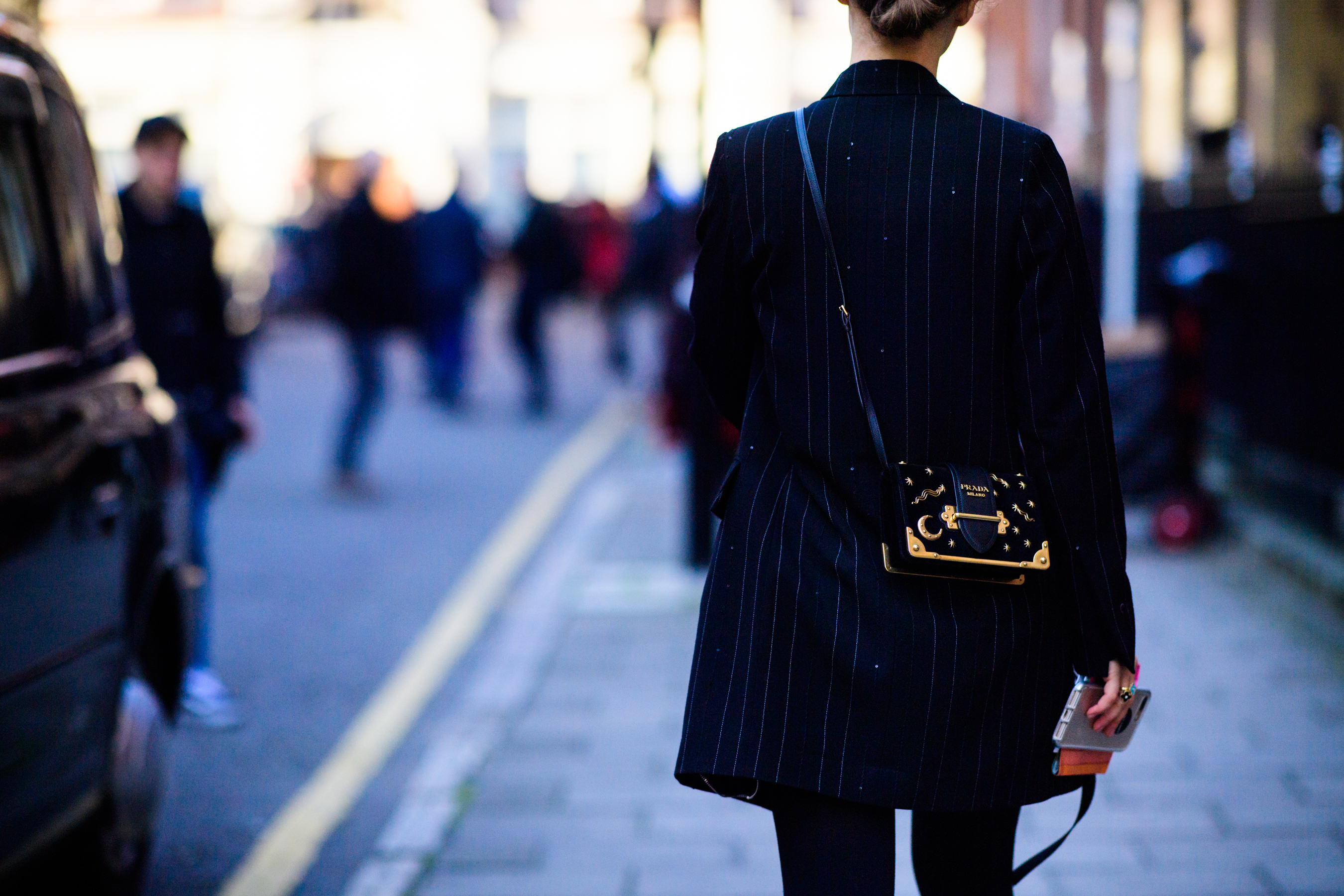 Woman wearing Prada bag