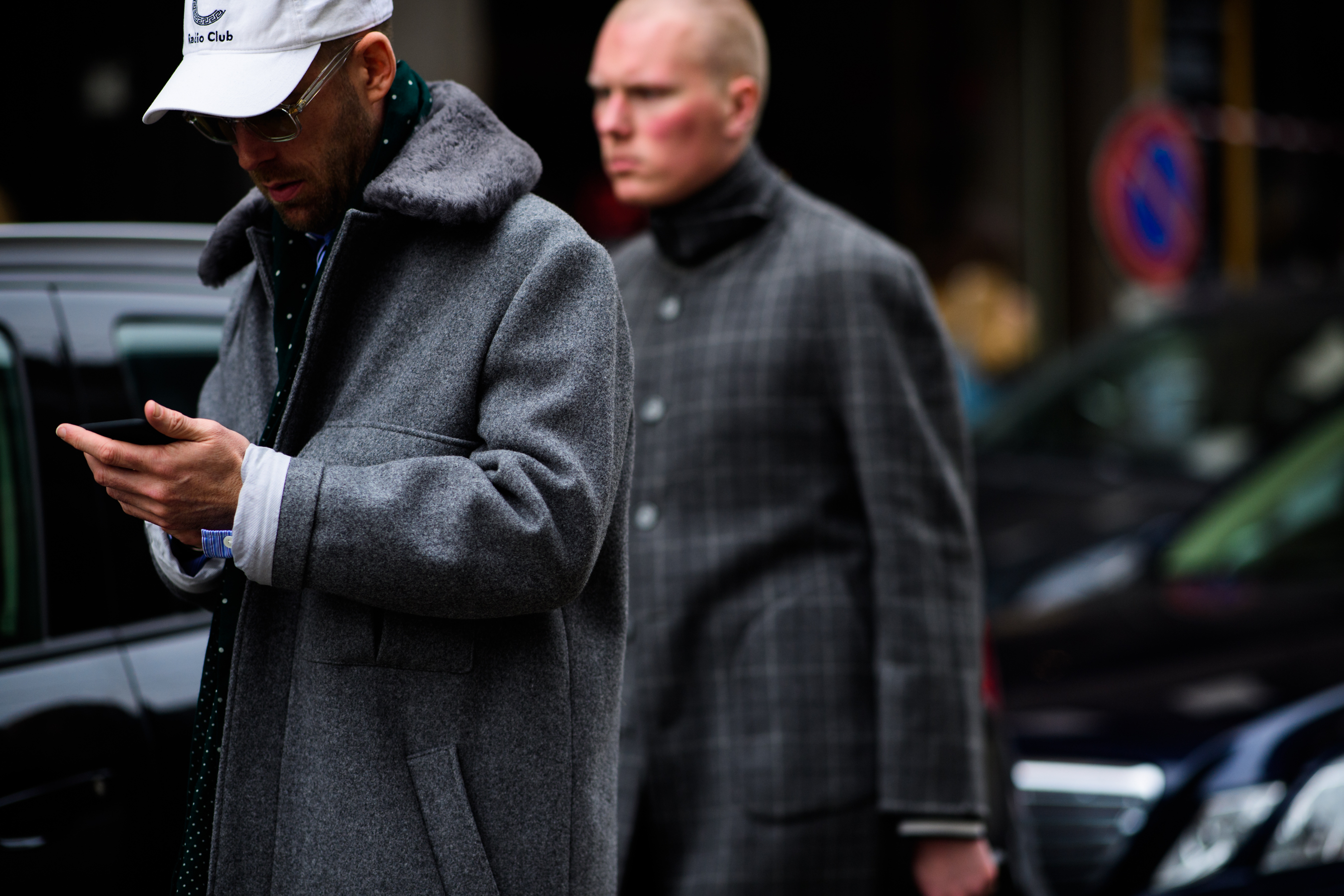 Men wearing grey coats