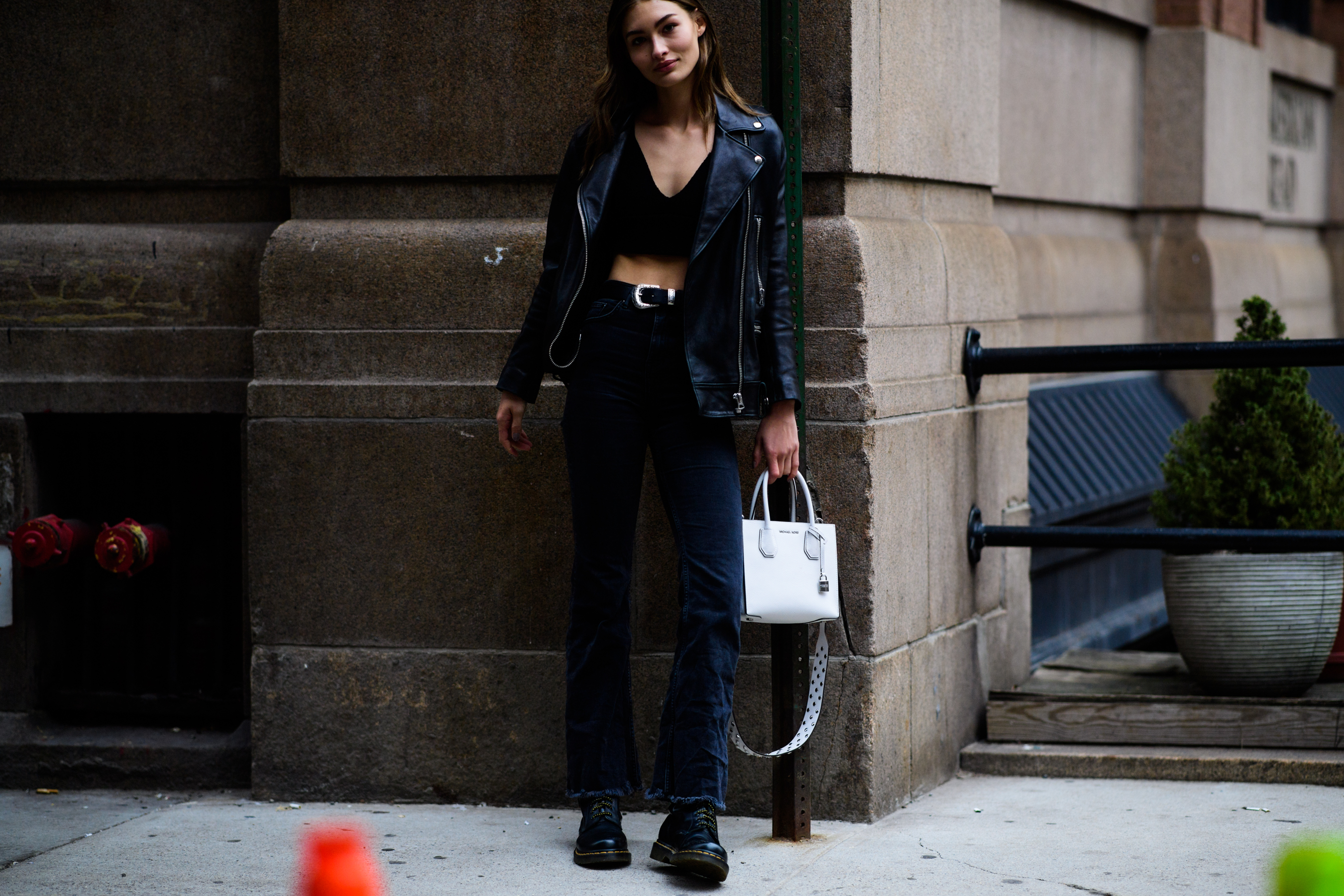 Woman wearing denim pants and leather jacket