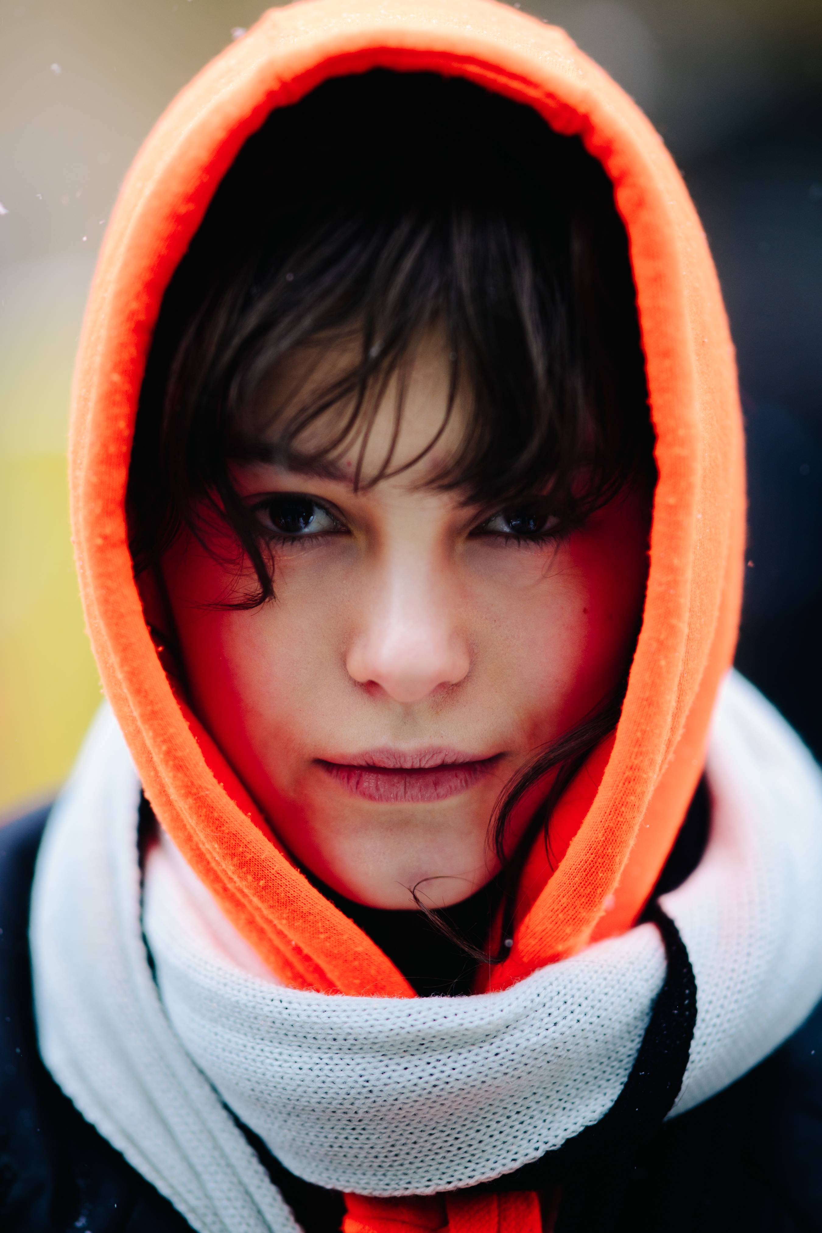 Woman wearing orange hoodie and scarf