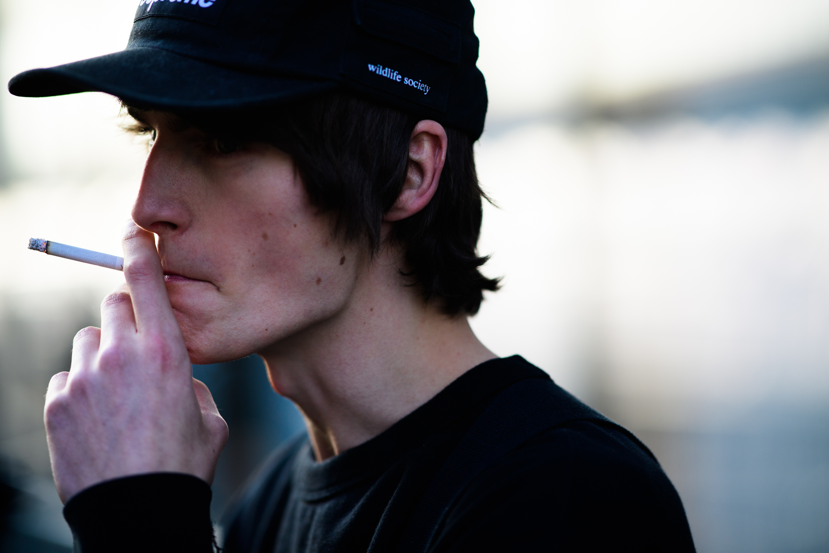 Male model wearing supreme cap