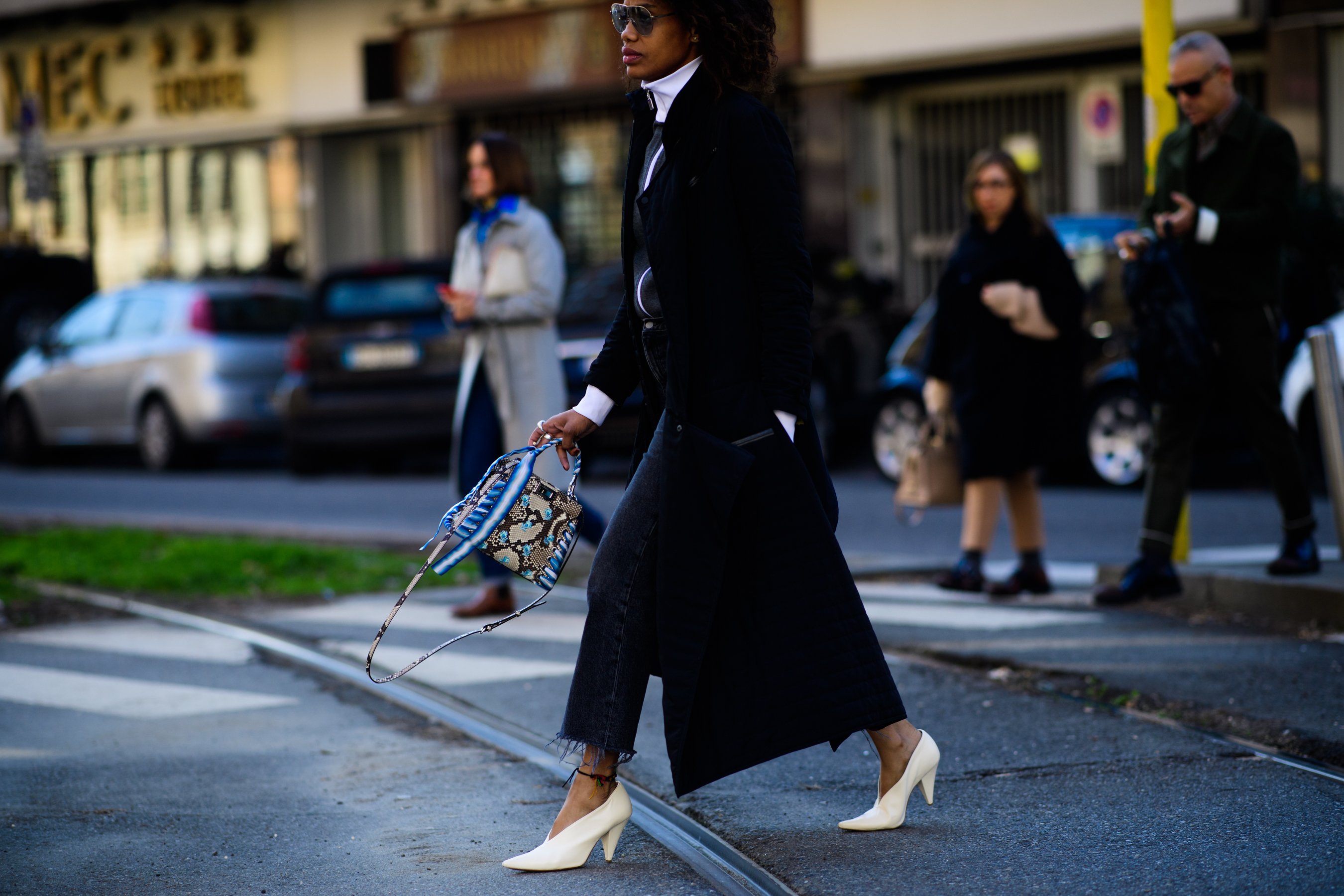 Woman wearing black clothes and shite shoes