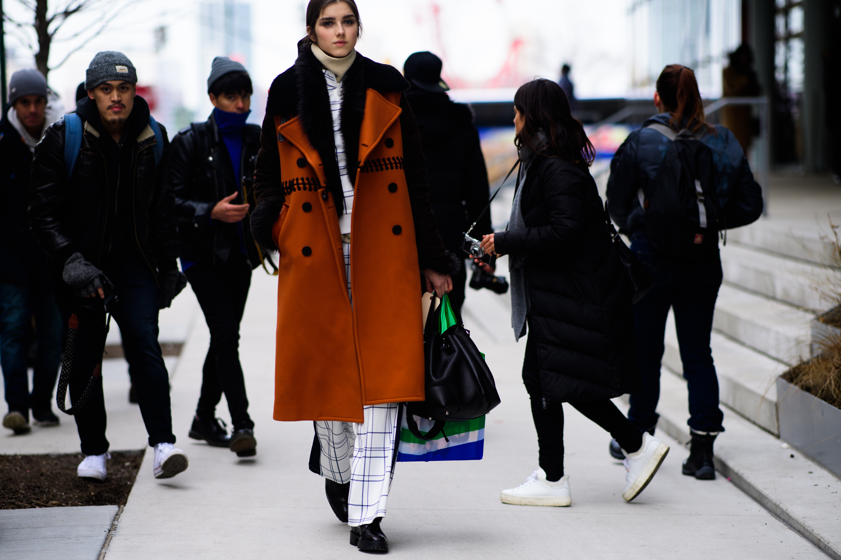 Model wearing oversized orange coat